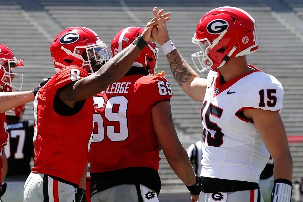 Georgia wide receiver Colbie Young (8) coal celebrates with Georgia quarterback Carson Beck (15) after scoring a touchdown during the G-Day spring football game in Athens, Ga., on Saturday, April 13.