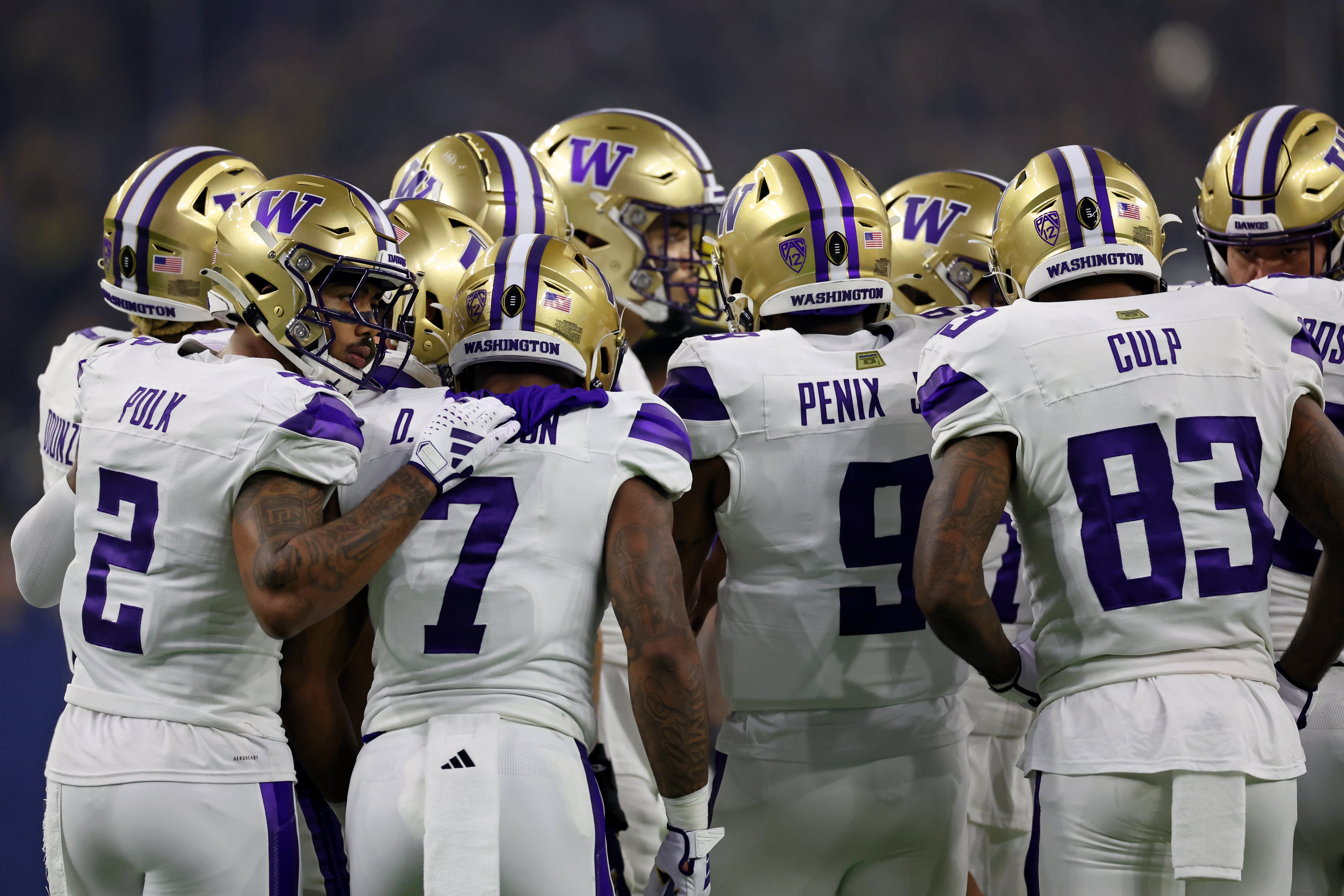 Jan 8, 2024; Houston, TX, USA; Washington Huskies players huddle against the Michigan Wolverines during the first quarter in the 2024 College Football Playoff national championship game at NRG Stadium. Mandatory Credit: Thomas Shea-USA TODAY Sports