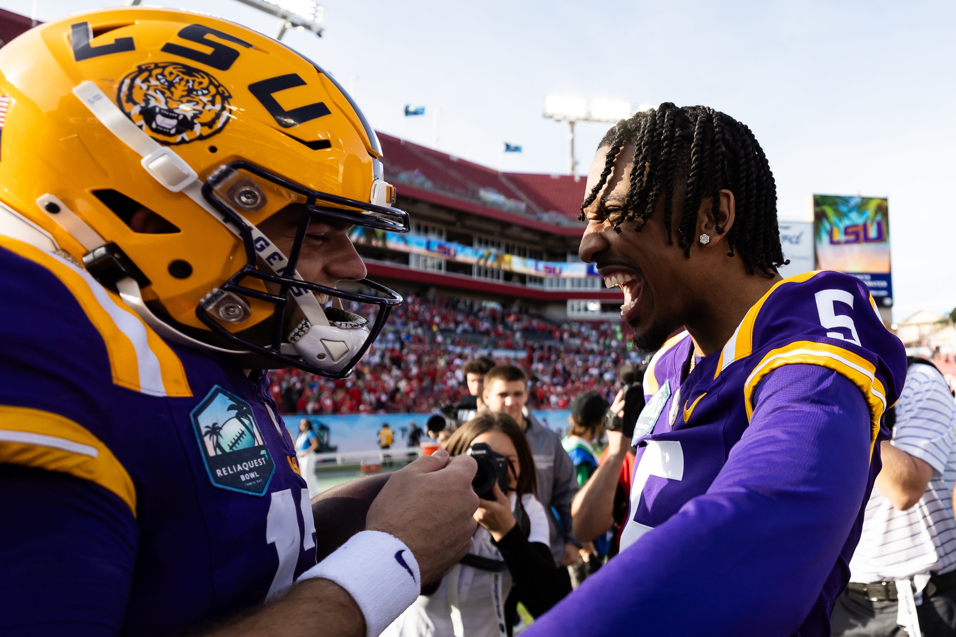 Jan 1, 2024; Tampa, FL, USA; LSU Tigers quarterbacks Garrett Nussmeier, left, and Jayden Daniels (5) celebrate after the game against the Wisconsin Badgers at the Reliaquest Bowl at Raymond James Stadium.