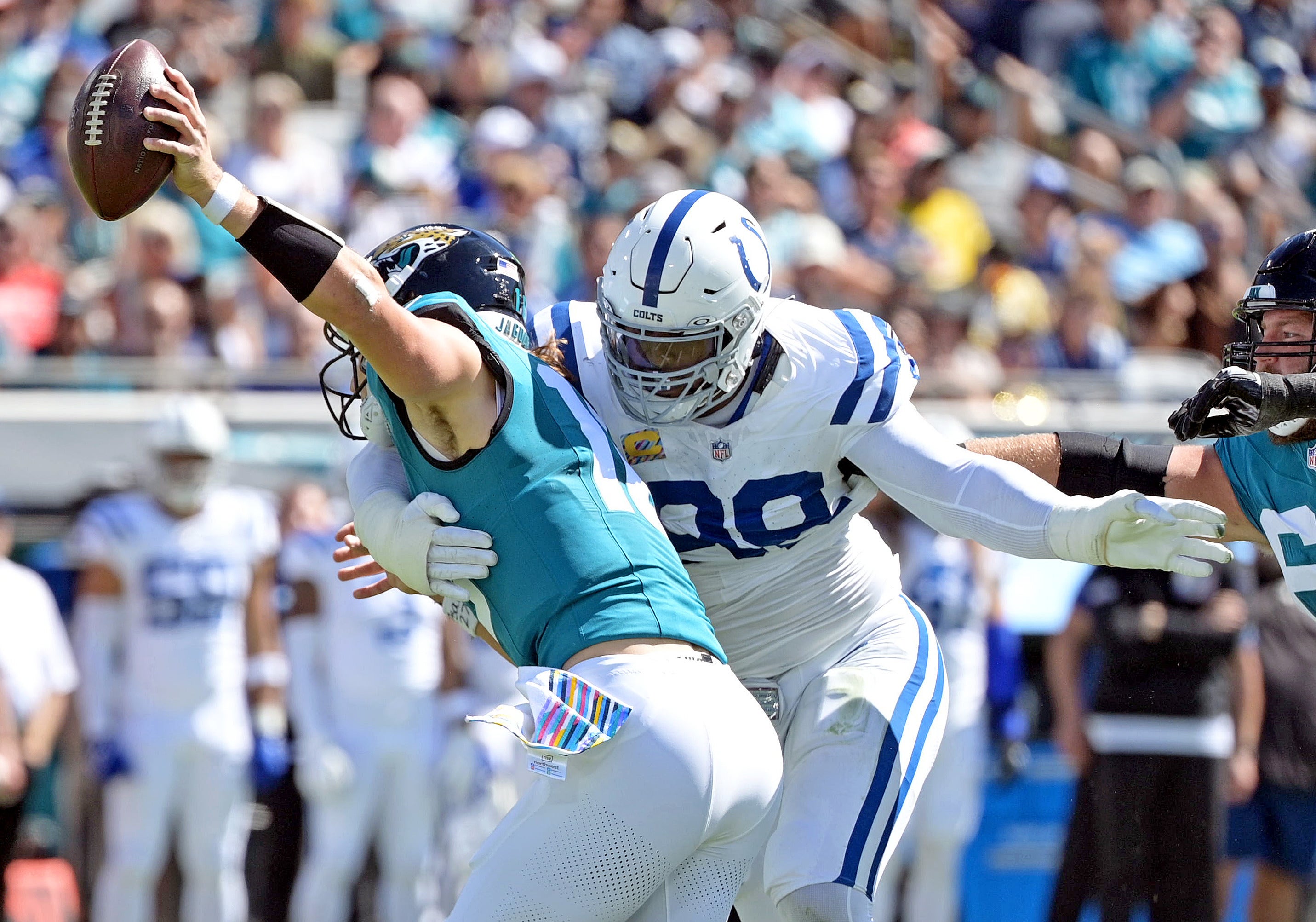 Oct 15, 2023; Jacksonville, Florida, USA; Indianapolis Colts defensive end DeForest Buckner (99) sacks Jacksonville Jaguars quarterback Trevor Lawrence (16) during the first half at EverBank Stadium.