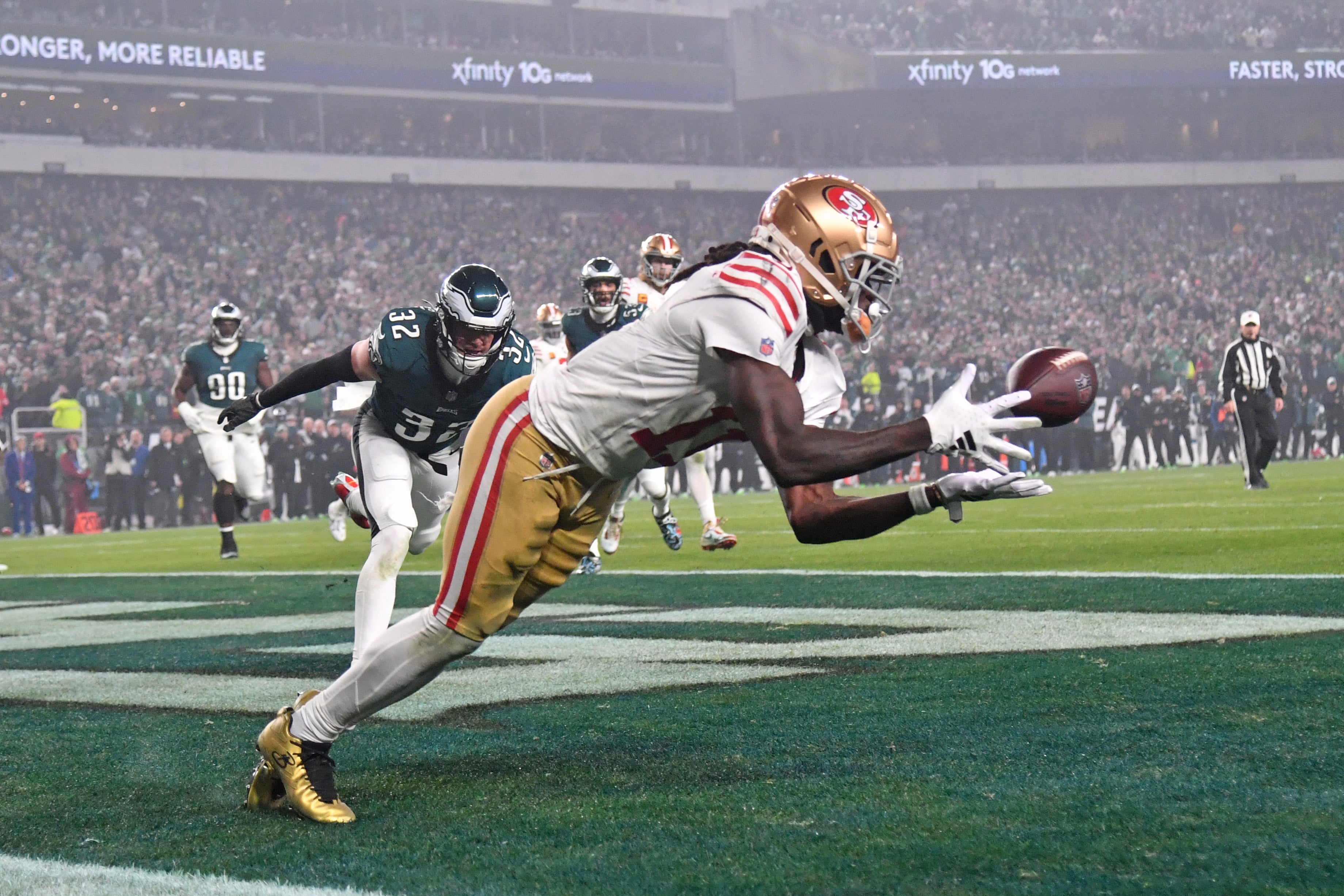 Dec 3, 2023; Philadelphia, Pennsylvania, USA; San Francisco 49ers wide receiver Brandon Aiyuk (11) catches touchdown pass against Philadelphia Eagles safety Reed Blankenship (32) during the second quarter at Lincoln Financial Field.
