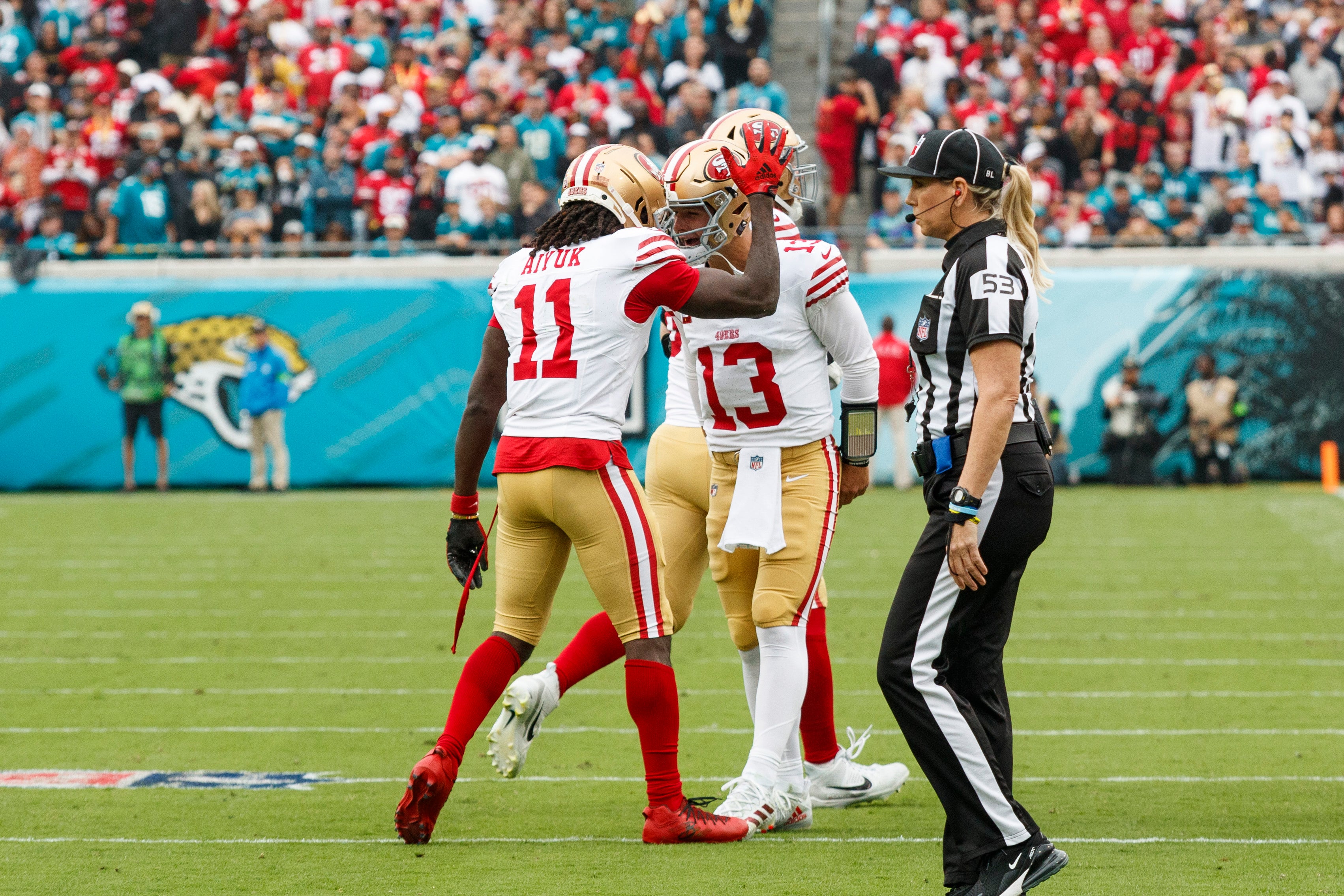 Nov 12, 2023; Jacksonville, Florida, USA; San Francisco 49ers wide receiver Brandon Aiyuk (11) and quarterback Brock Purdy (13) celebrate a touchdown against the Jacksonville Jaguars during the first quarter at EverBank Stadium.