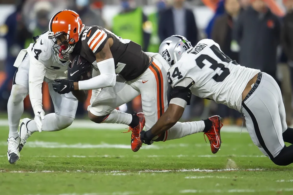 Las Vegas Raiders safety Johnathan Abram (24) and outside linebacker K.J. Wright (34) tackle Cleveland Browns wide receiver Rashard Higgins (82) during the first half at FirstEnergy Stadium.