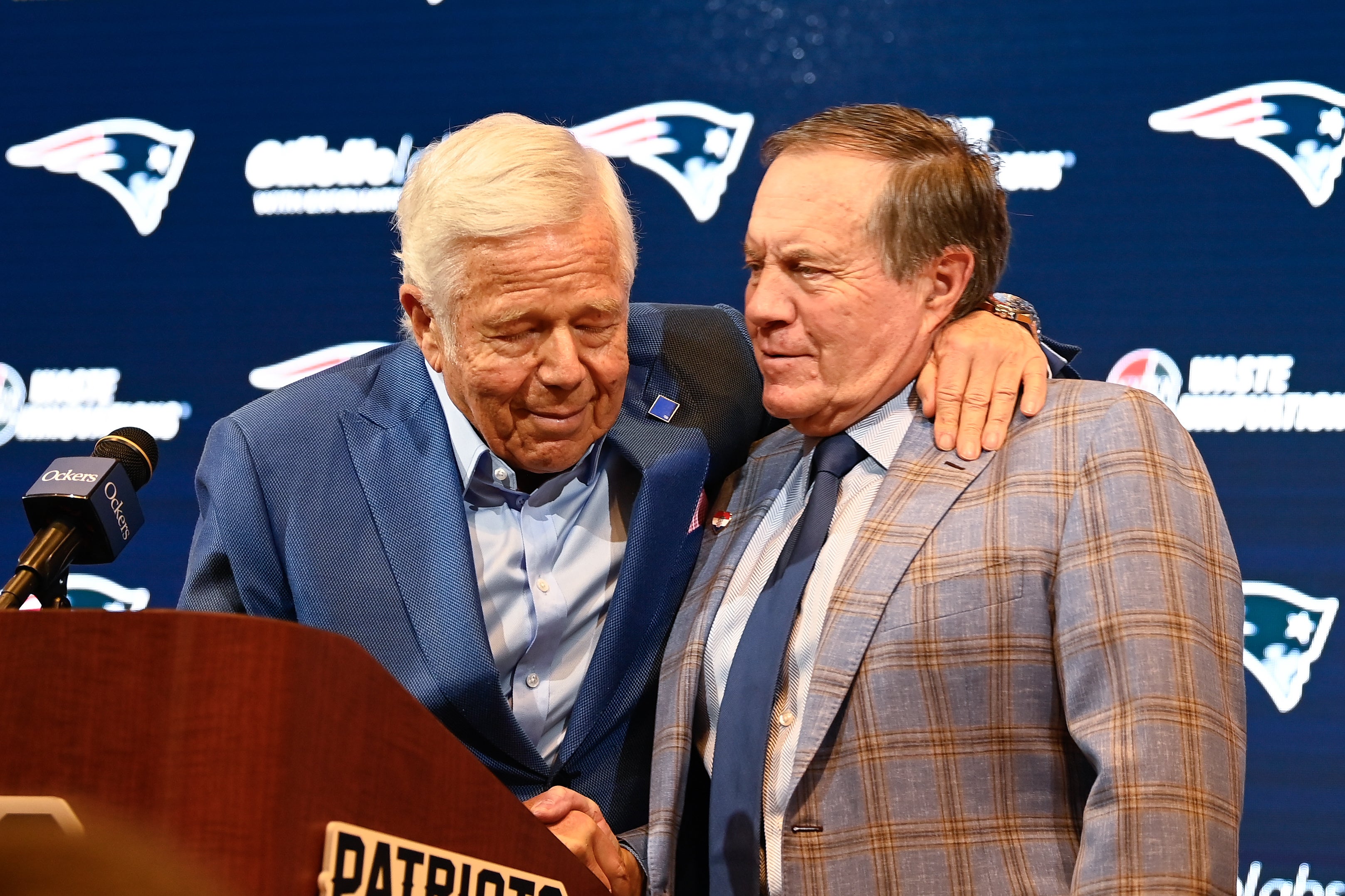 Jan 11, 2024; Foxborough, MA, USA; New England Patriots former head coach Bill Belichick (right) embraces Patriots owner Robert Kraft (left) during a press conference at Gillette Stadium to announce Belichick's exit from the team