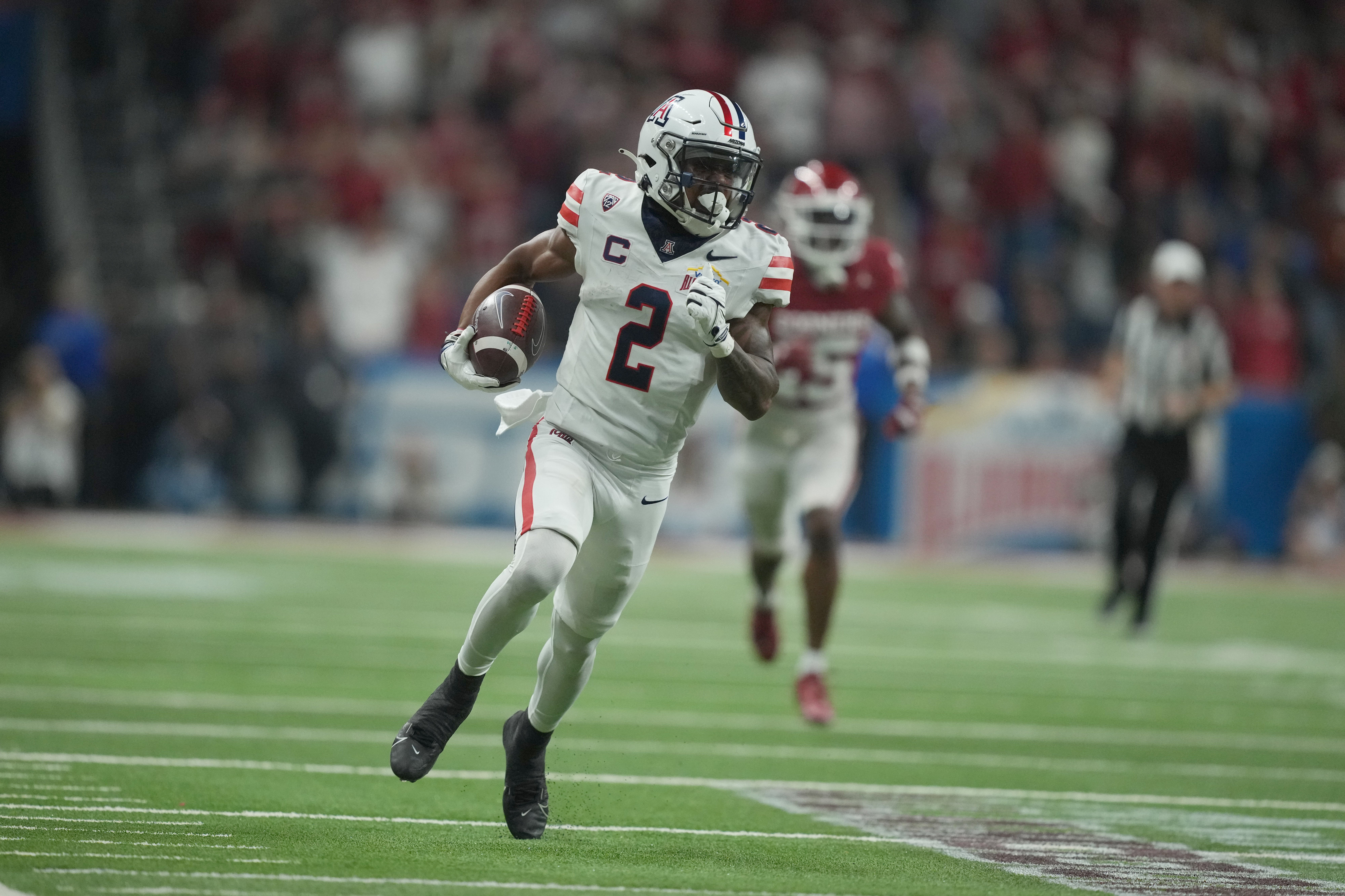 Dec 28, 2023; San Antonio, TX, USA; Arizona Wildcats wide receiver Jacob Cowing (2) scores on a 57-yard touchdown reception against the Oklahoma Sooners in the second half of the Alamo Bowl at Alamodome.