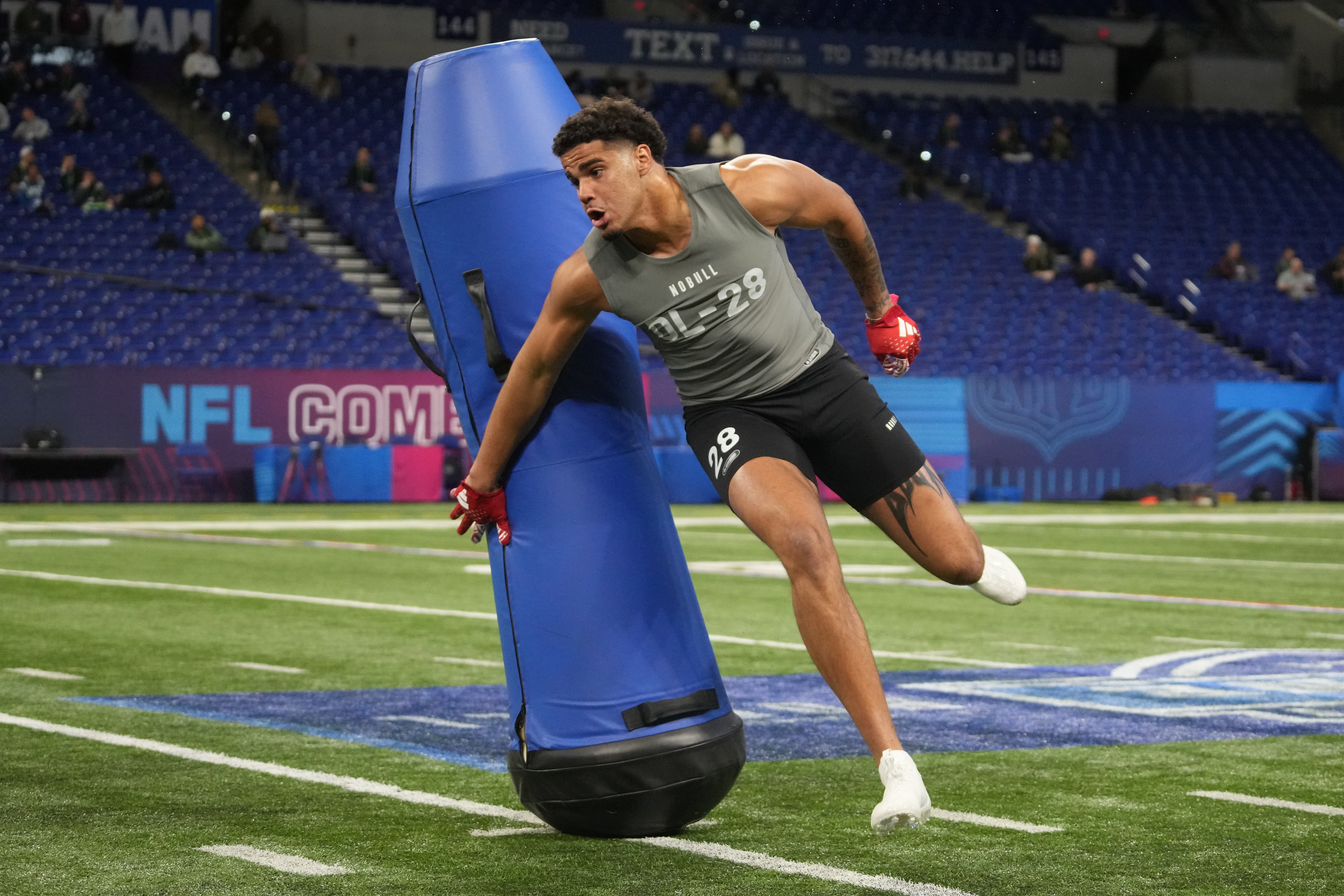 Feb 29, 2024; Indianapolis, IN, USA; Kansas defensive lineman Austin Booker (DL28) works out during the 2024 NFL Combine at Lucas Oil Stadium.