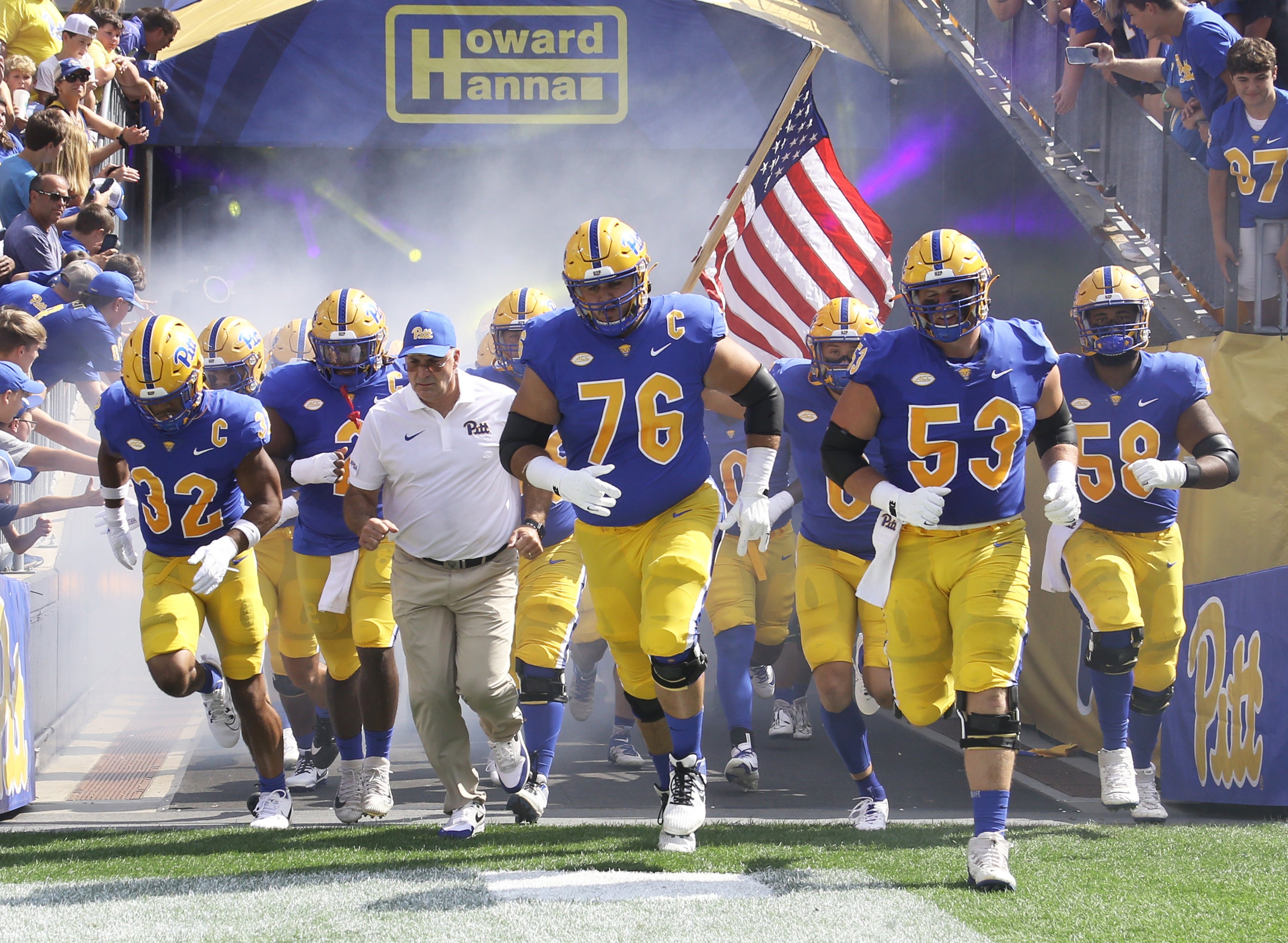 Sep 2, 2023; Pittsburgh, Pennsylvania, USA; Pittsburgh Panthers linebacker Shayne Simon (32) and offensive tackle Matt Goncalves (76) and center Jake Kradel (53) lead the team onto the field alongside head coach Pat Narduzzi (white shirt) to play the Wofford Terriers at Acrisure Stadium.