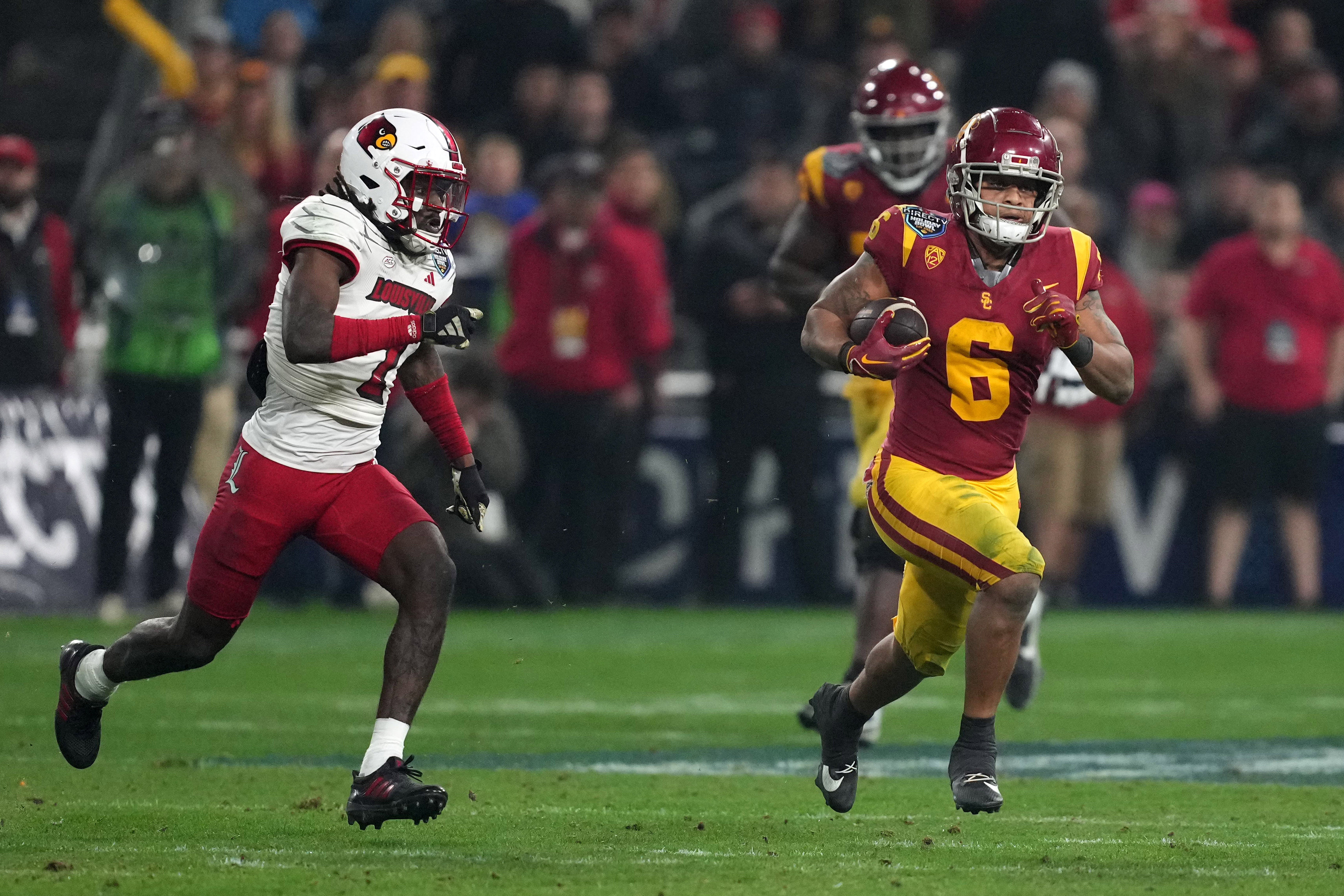 Dec 27, 2023; San Diego, CA, USA; Southern California Trojans running back Austin Jones (6) carries the ball against the Louisville Cardinals in the second half of the Holiday Bowl at Petco Park.