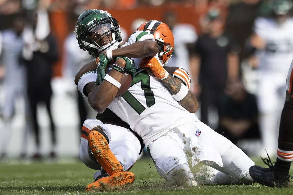 New York Jets wide receiver Garrett Wilson (17) is tackled from behind by Cleveland Browns safety Grant Delpit (22) during the fourth quarter at FirstEnergy Stadium.
