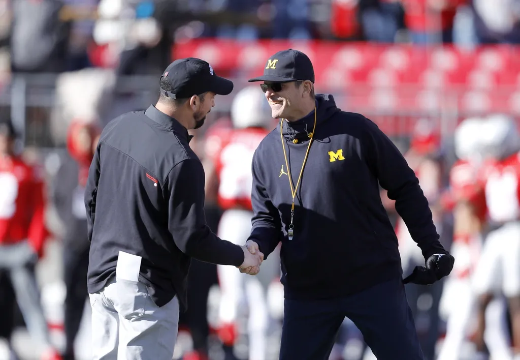 Michigan Wolverines head coach Jim Harbaugh (right) and Ohio State Buckeyes head coach Ryan Day (left) shake hands before the game at Ohio Stadium.