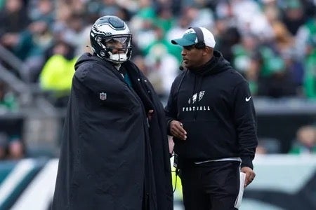 Philadelphia Eagles quarterback Jalen Hurts (L) and offensive coordinator Brian Johnson (R) talks during a timeout in the second quarter against the Arizona Cardinals at Lincoln Financial Field.
