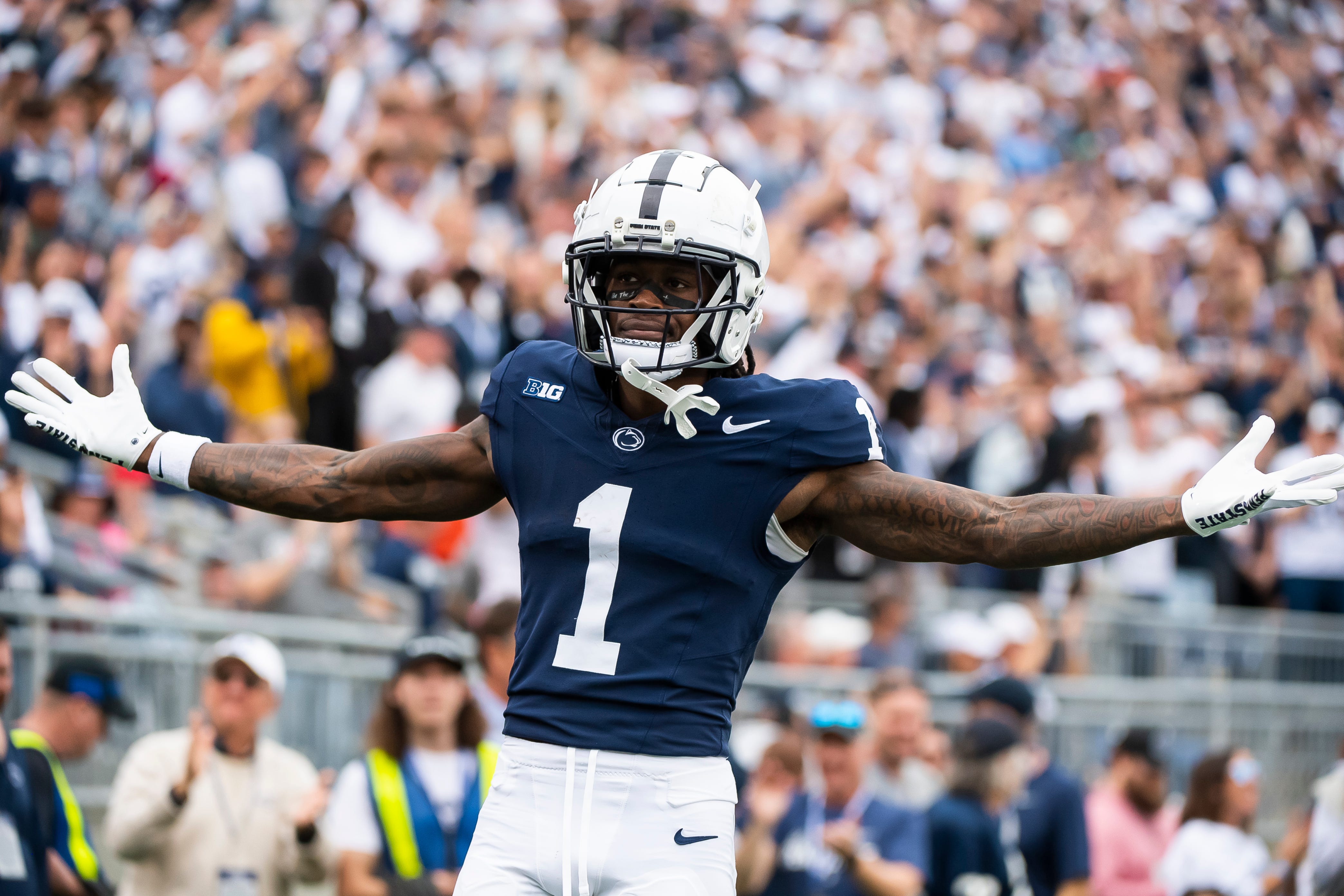 Penn State wide receiver KeAndre Lambert-Smith (1) motions to the crowd after scoring a touchdown on a 57-yard reception late in the fourth quarter of an NCAA football game against Indiana at Beaver Stadium Saturday, Oct. 28, 2023, in State College, Pa. Lambert-Smith's touchdown broke a 24-24 tie and helped seal a 33-24 win for the Nittany Lions.