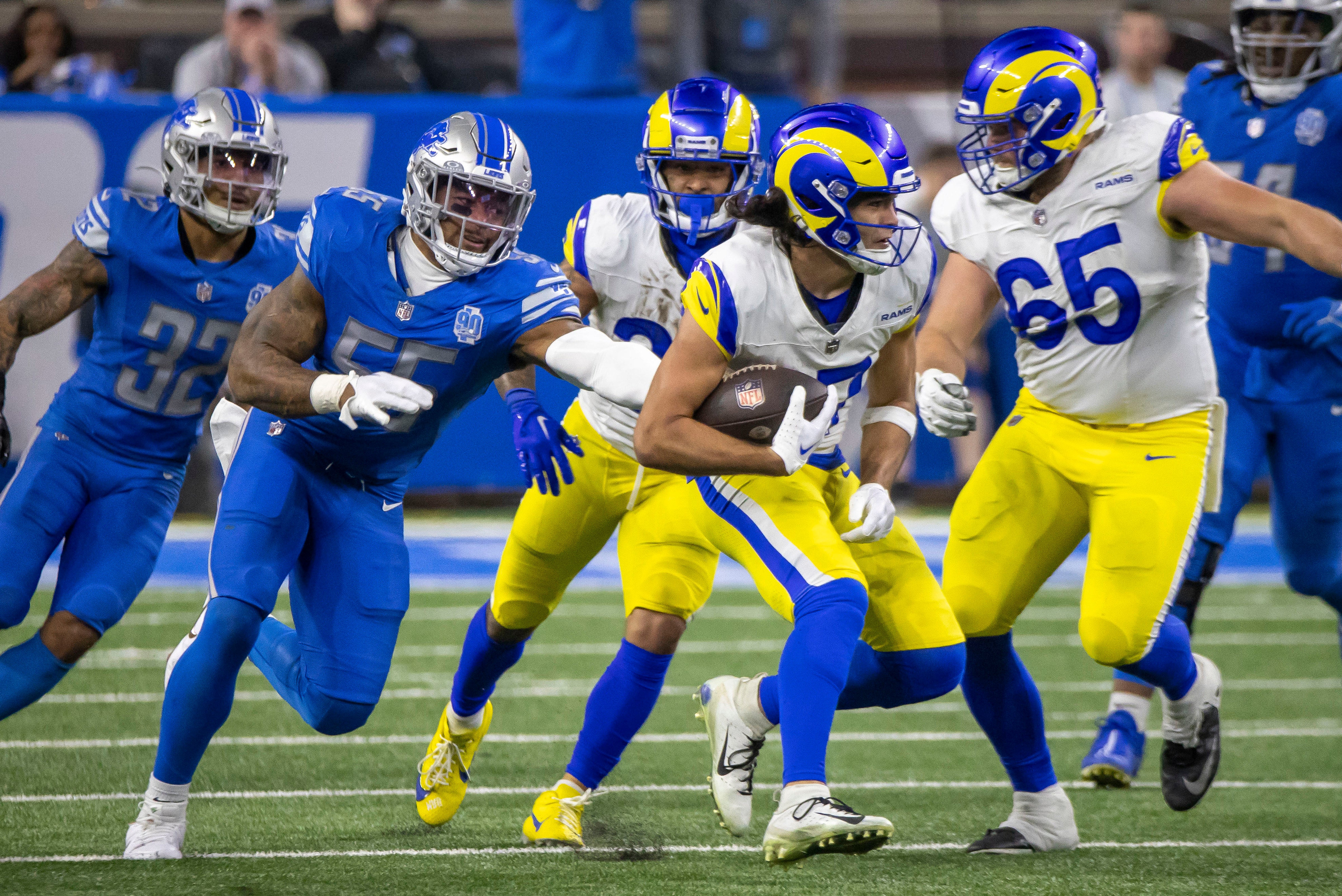 Jan 14, 2024; Detroit, Michigan, USA; Los Angeles Rams wide receiver Puka Nacua (17) runs against Detroit Lions linebacker Derrick Barnes (55) during the second half of a 2024 NFC wild card game at Ford Field. Mandatory Credit: David Reginek-USA TODAY Sports