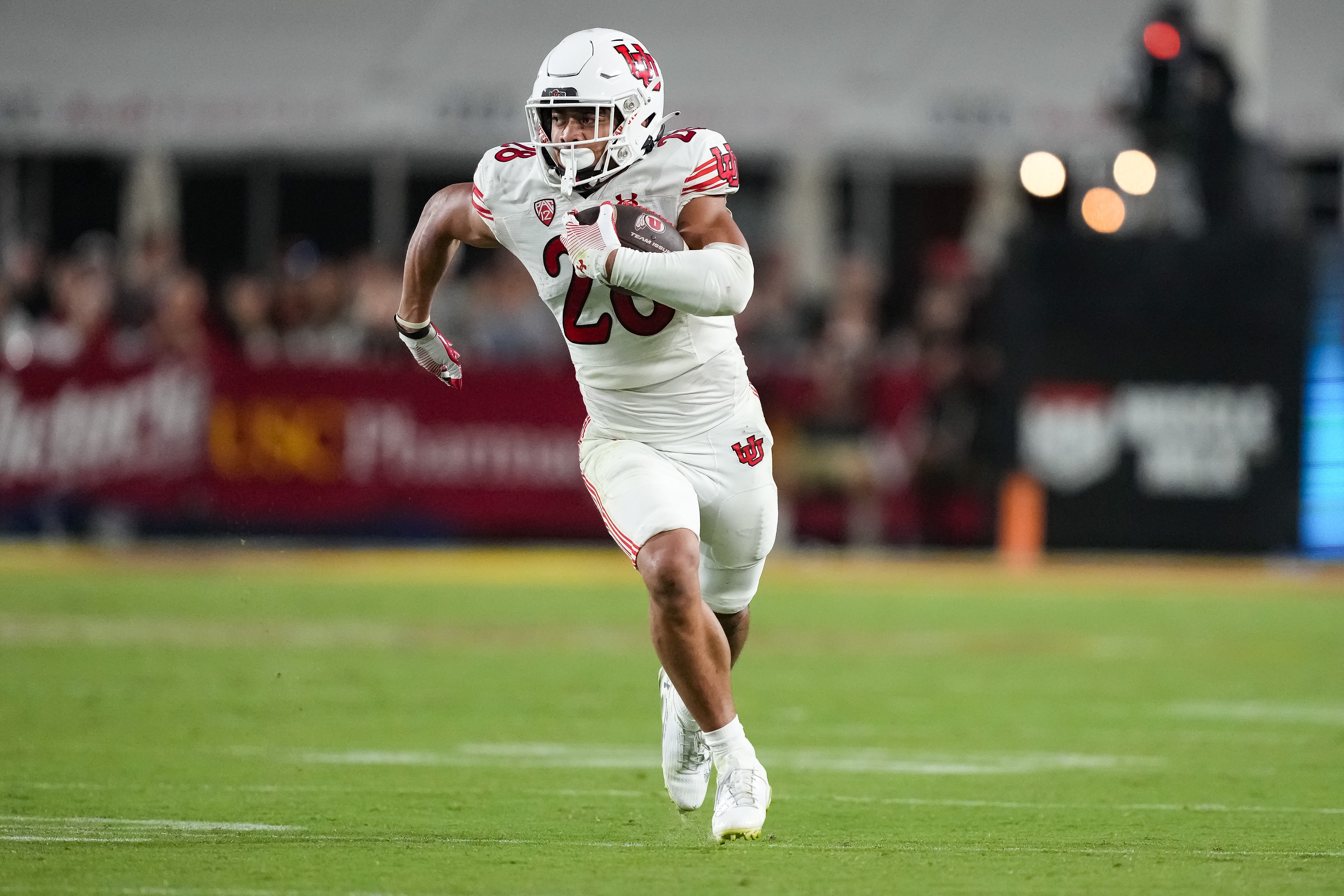 Oct 21, 2023; Los Angeles, California, USA; Utah Utes running back Sione Vaki (28) carries the ball against the Southern California Trojans in the second half at United Airlines Field at Los Angeles Memorial Coliseum.