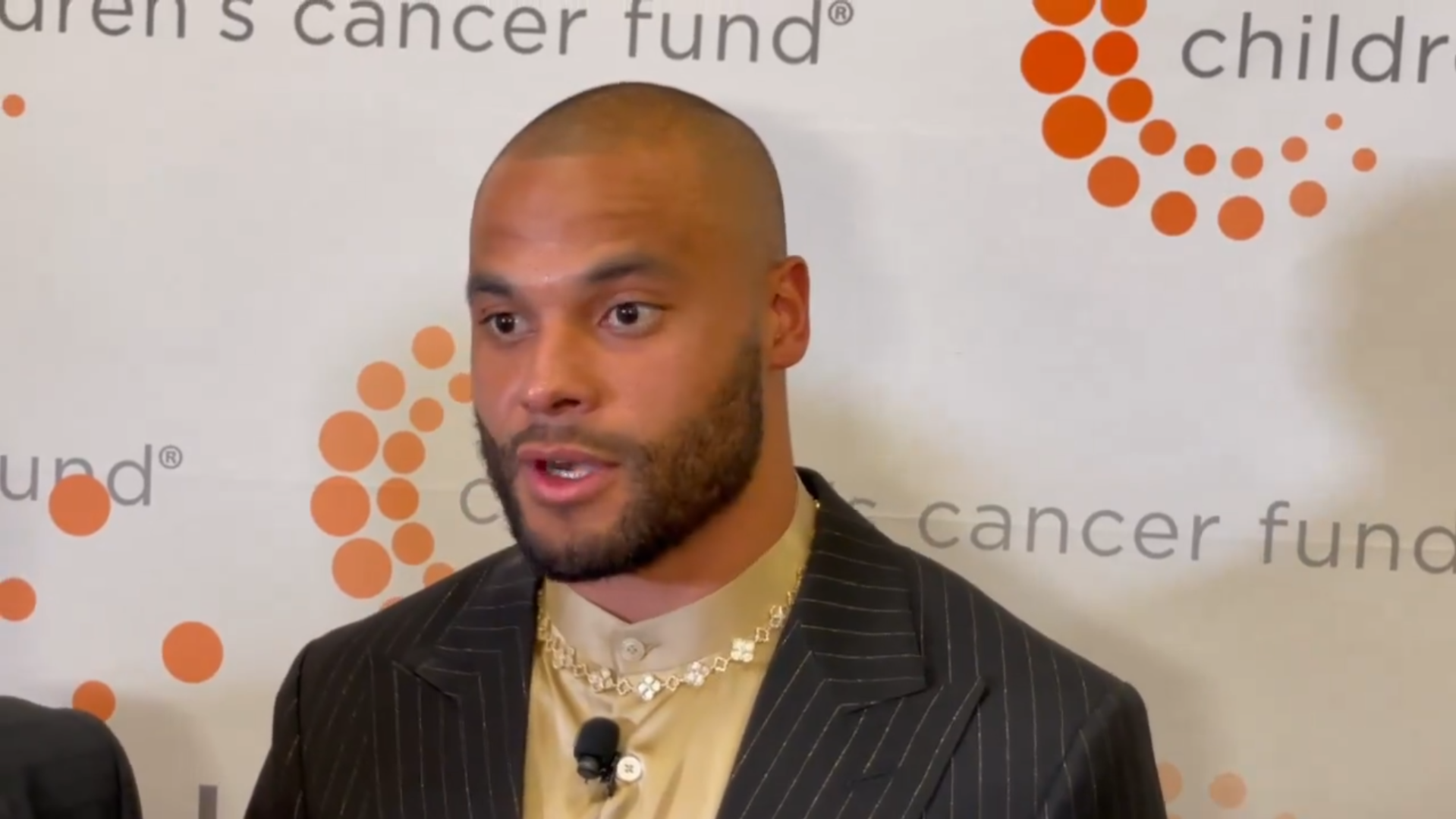 Dallas Cowboys QB Dak Prescott talks to reporters at charity event.