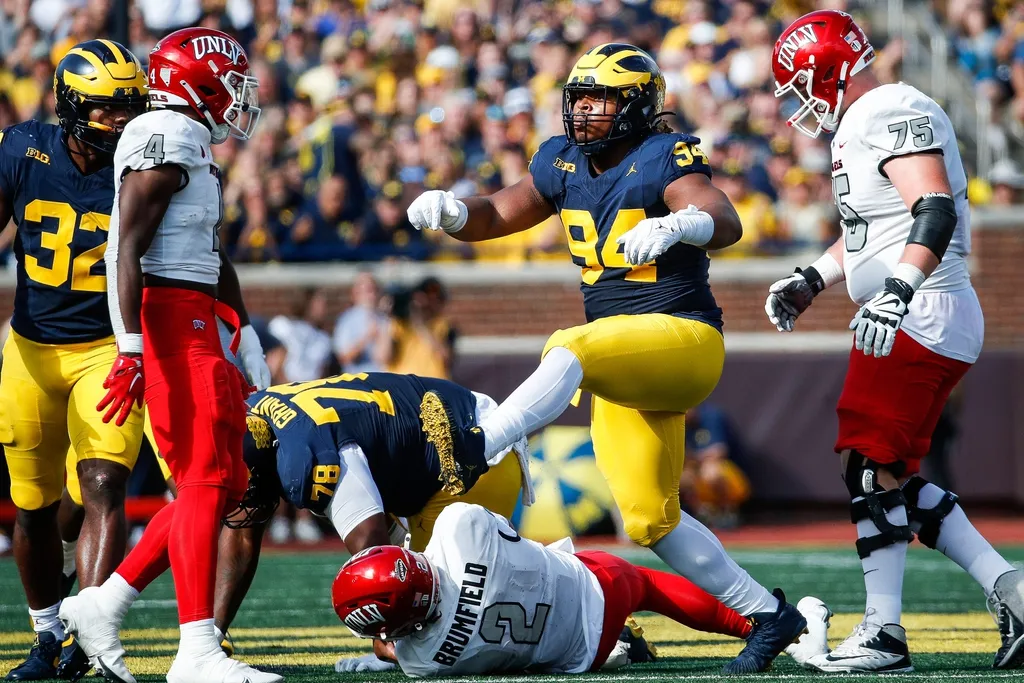 Michigan defensive lineman Kris Jenkins (94) celebrates a sack against UNLV quarterback Doug Brumfield (2) during the first half at Michigan Stadium in Ann Arbor on Saturday, Sept. 9, 2023
