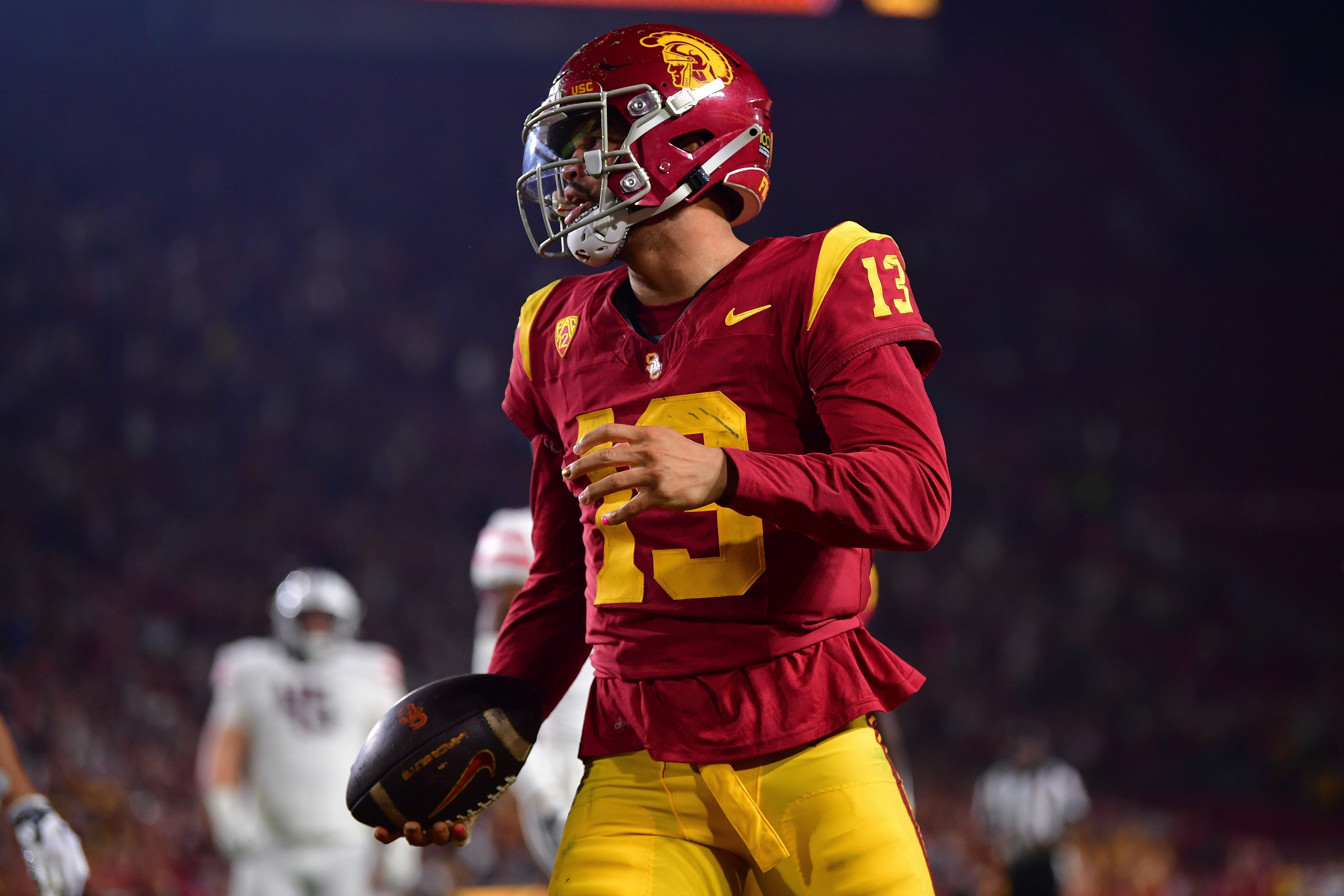 Oct 7, 2023; Los Angeles, California, USA; Southern California Trojans quarterback Caleb Williams (13) celebrates his touchdown scored against the Arizona Wildcats during the first overtime at Los Angeles Memorial Coliseum.