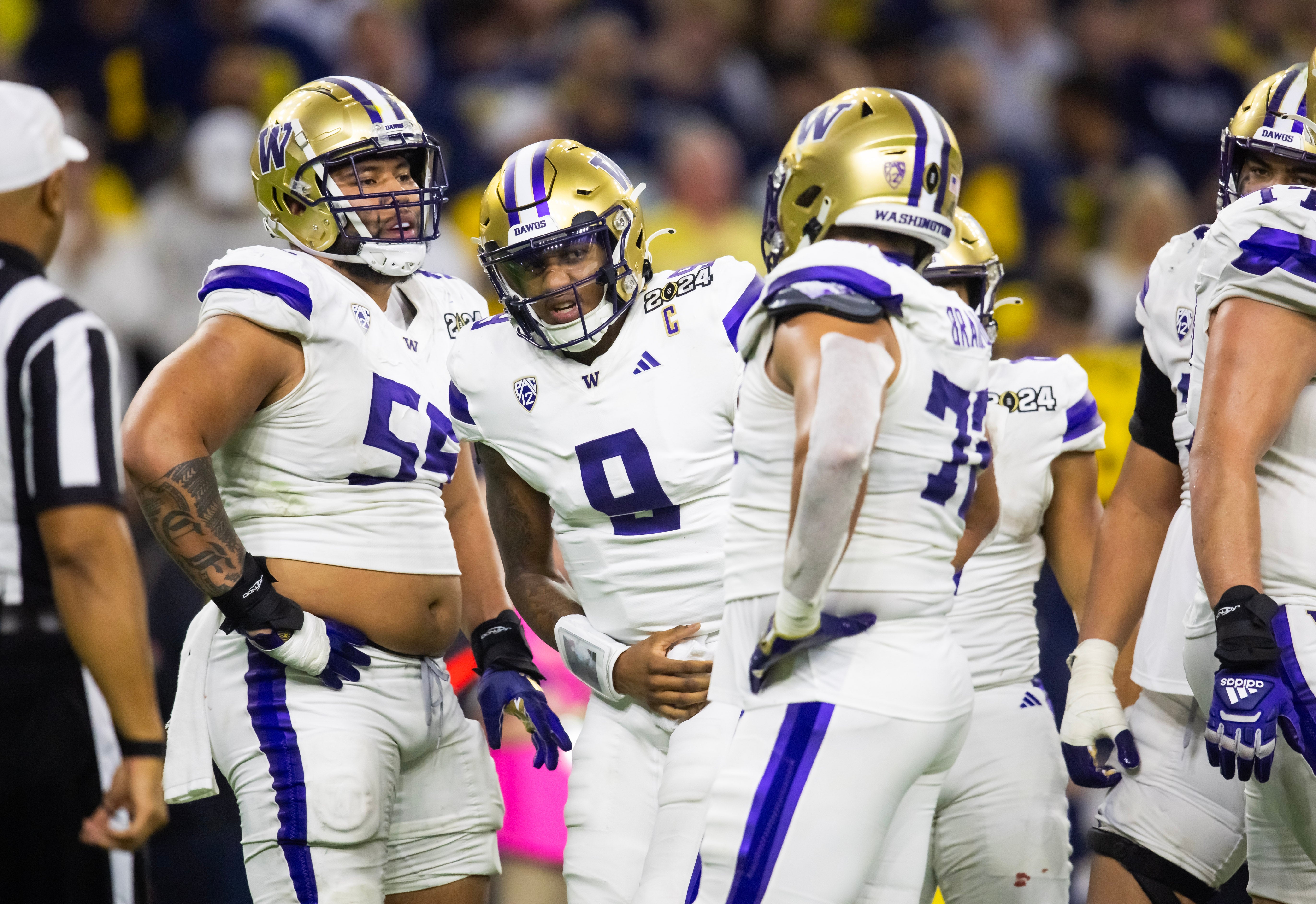 Jan 8, 2024; Houston, TX, USA; Washington Huskies quarterback Michael Penix Jr. (9) reacts after suffering an injury next to offensive lineman Troy Fautanu (55) in the fourth quarter against the Michigan Wolverines during the 2024 College Football Playoff national championship game at NRG Stadium. Mandatory Credit: Mark J. Rebilas-USA TODAY Sports