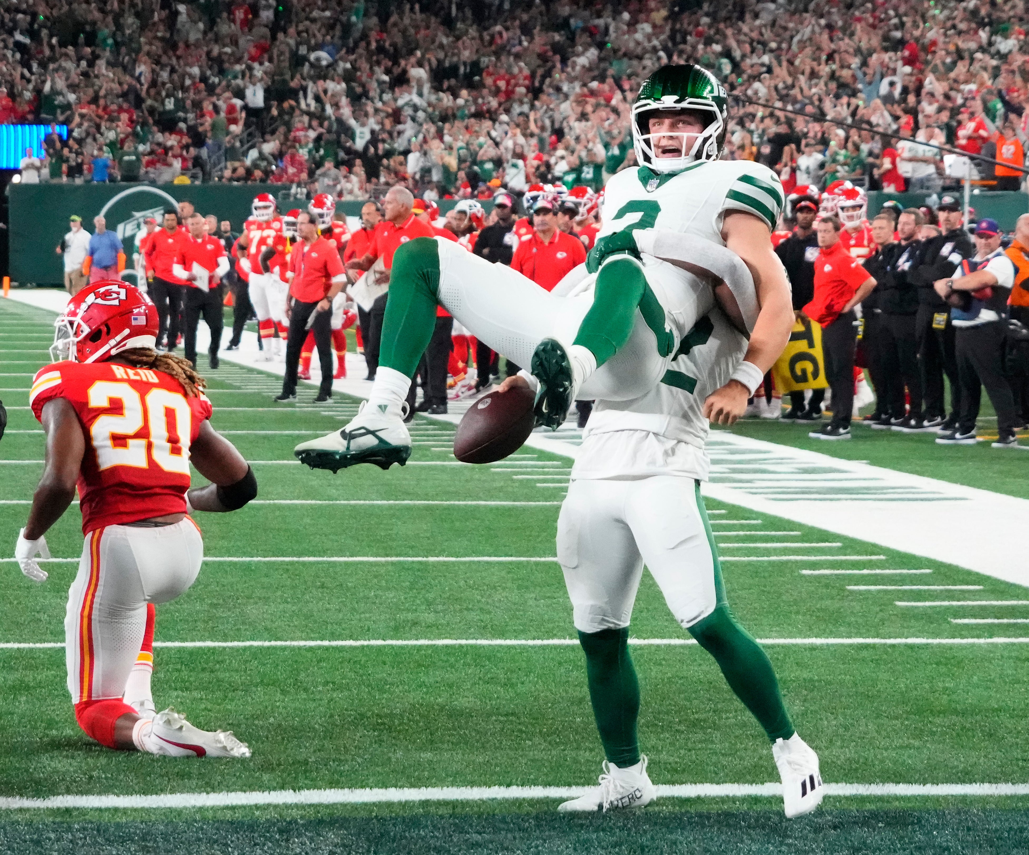 Oct 1, 2023; East Rutherford, New Jersey, USA; New York Jets quarterback Zach Wilson (2) is hoisted up by running back Michael Carter (32) after Wilson s two point conversion run against the Chiefs at MetLife Stadium.