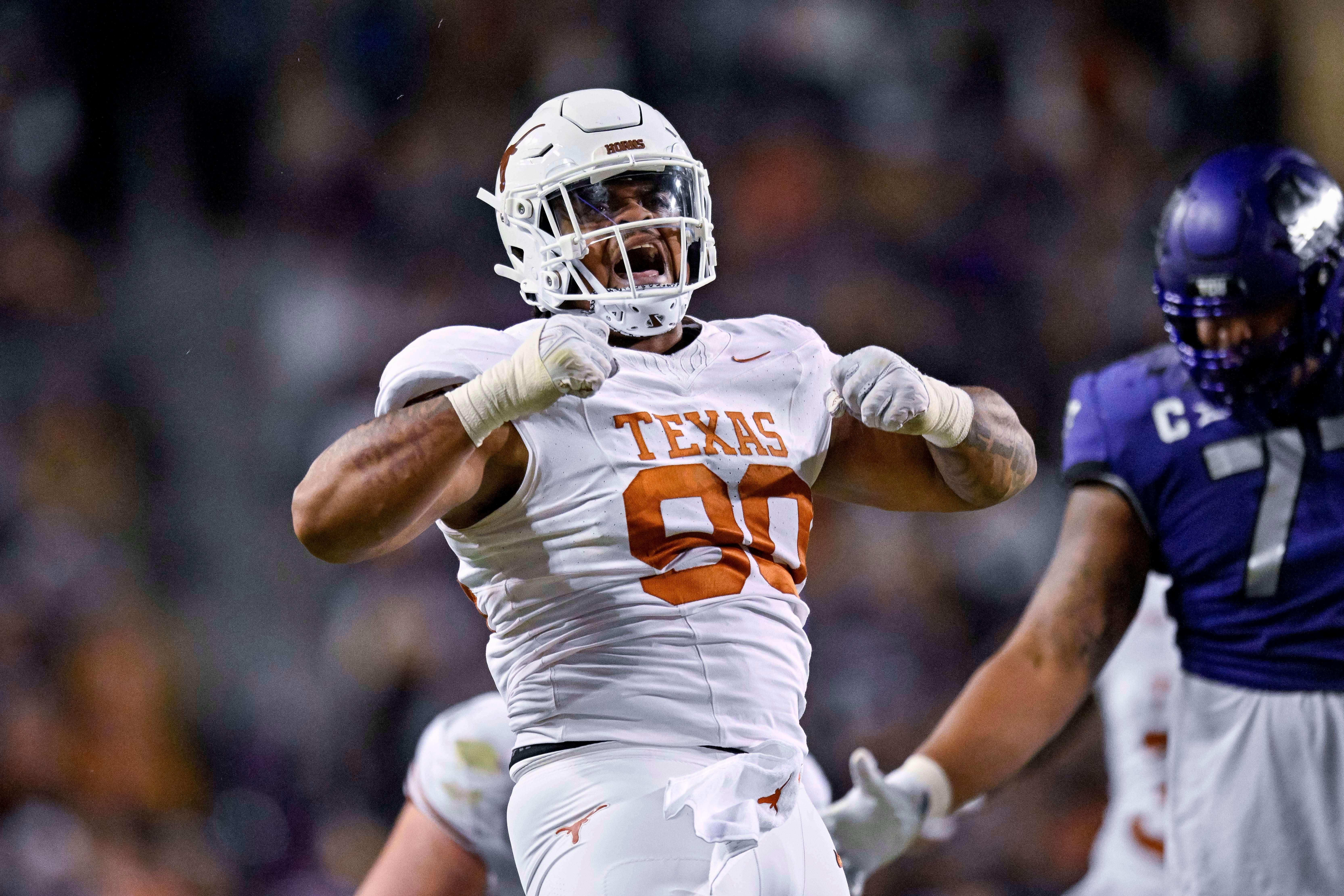 Nov 11, 2023; Fort Worth, Texas, USA; Texas Longhorns defensive lineman Byron Murphy II (90) celebrates after he sacks TCU Horned Frogs quarterback Josh Hoover (10) during the first half at Amon G. Carter Stadium.
