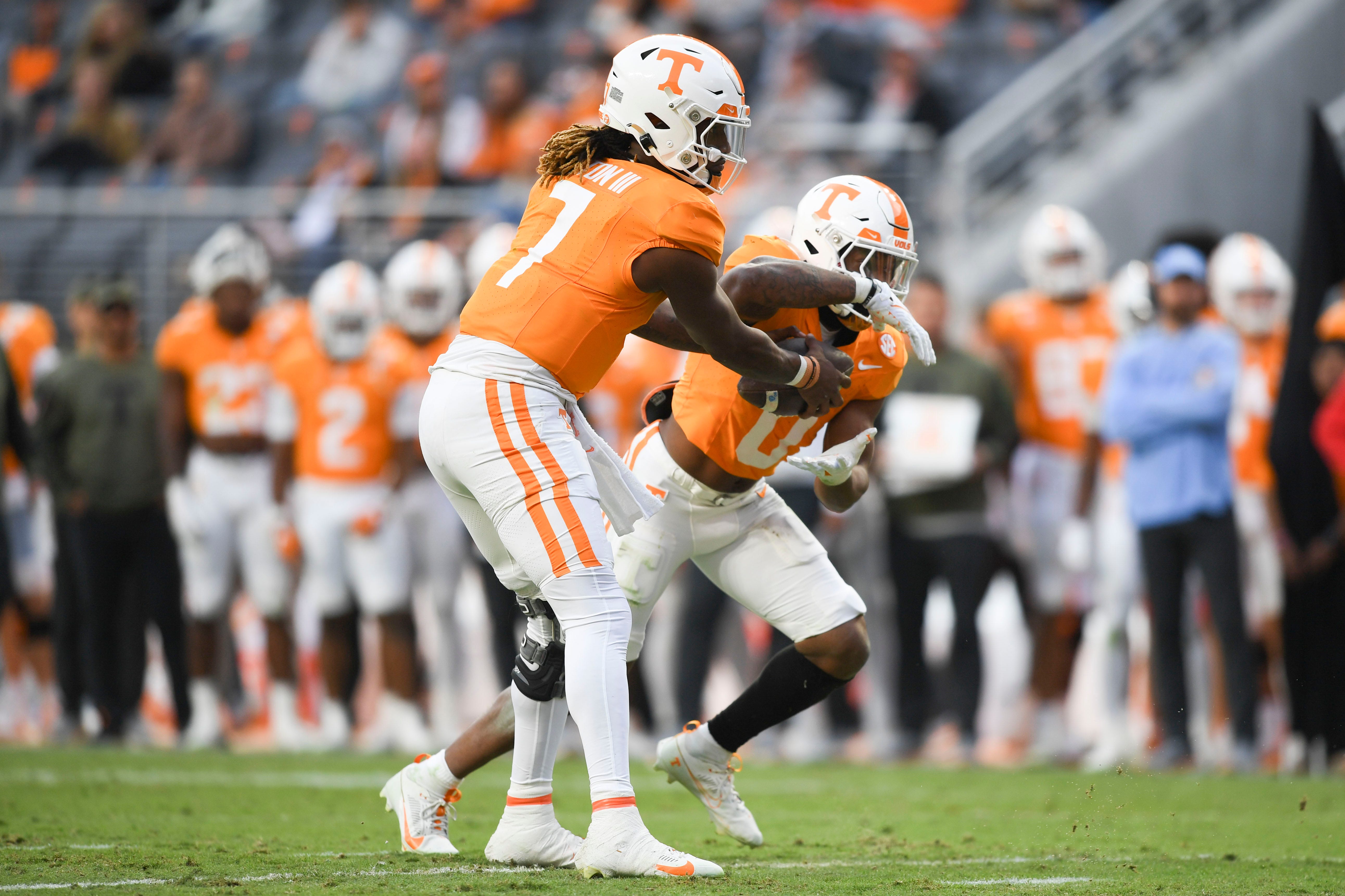 Tennessee running back Jaylen Wright (0) is handed the ball by Tennessee quarterback Joe Milton III (7) during a game between Tennessee and Vanderbilt at Neyland Stadium in Knoxville, Saturday, Nov. 25, 2023.