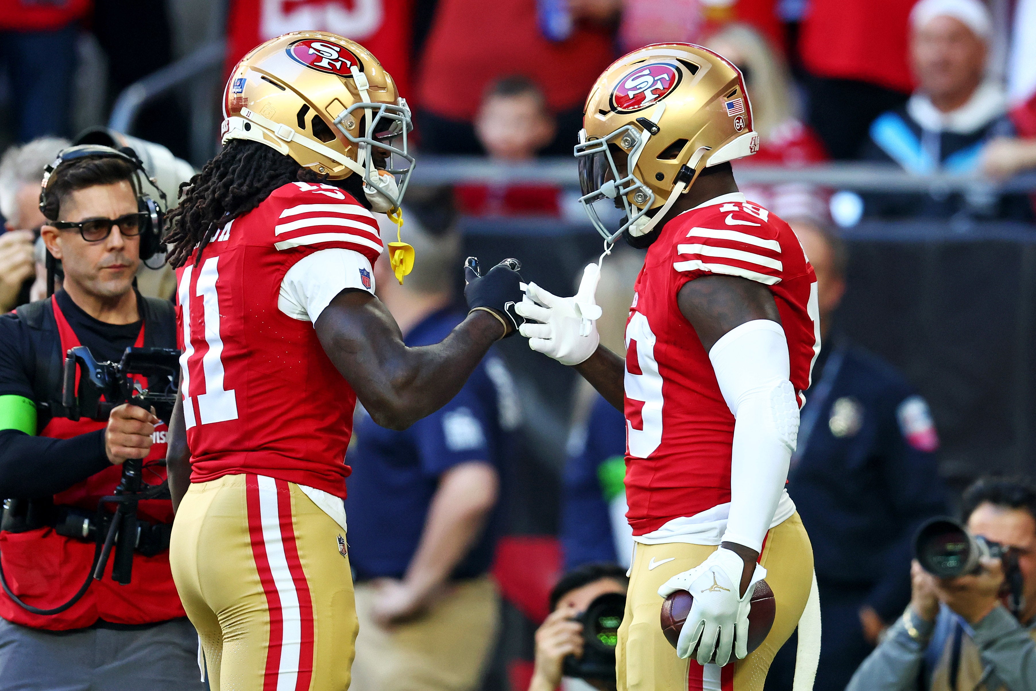 Dec 17, 2023; Glendale, Arizona, USA; San Francisco 49ers wide receiver Deebo Samuel (19) celebrates with wide receiver Brandon Aiyuk (11) after scoring a touchdown during the first quarter against the Arizona Cardinals at State Farm Stadium.