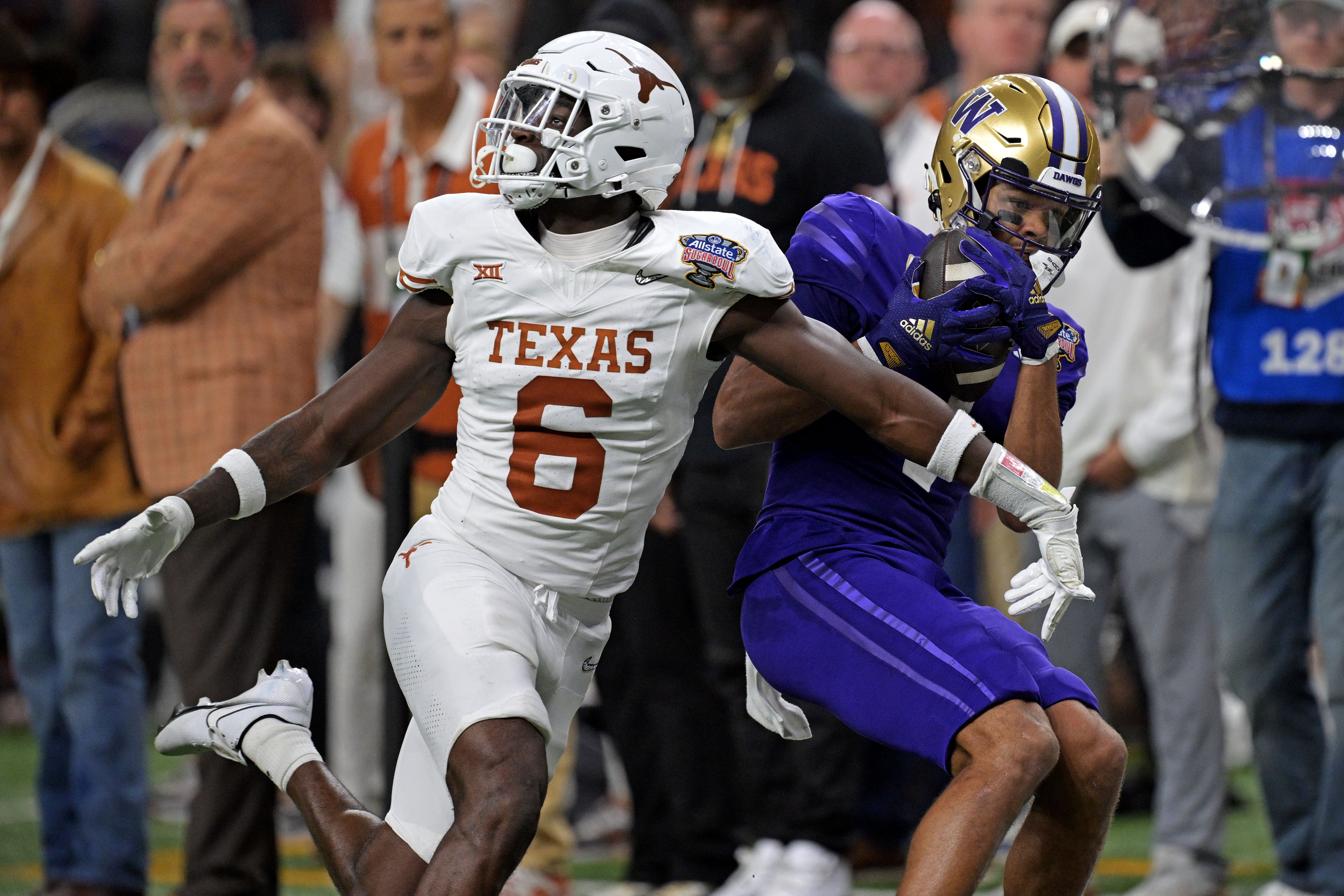 Jan 1, 2024; New Orleans, LA, USA; Washington Huskies wide receiver Rome Odunze (1) catches a pass against Texas Longhorns defensive back Ryan Watts (6) during the fourth quarter in the 2024 Sugar Bowl college football playoff semifinal game at Caesars Superdome. Mandatory Credit: Matthew Hinton-USA TODAY Sports