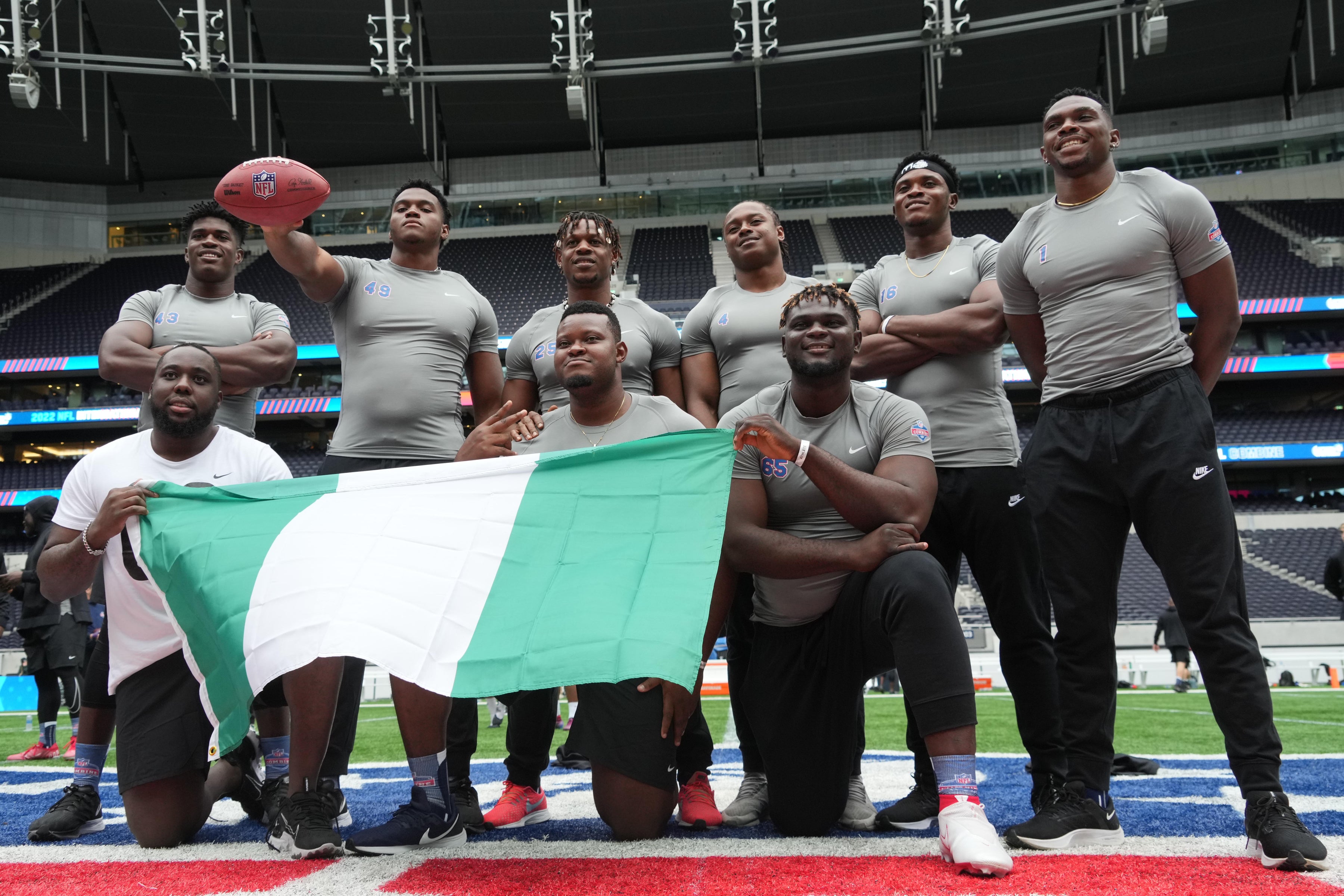 Oct 4, 2022; London, United Kingdom; Nigeria players Ebuka Emmanuel Nzekwe, Ifanyi Paul Anine, Ifeanyi Augustine Nwoye, Kenneth Odumegwu, Jason Godrick, Basil Chijoke Okoye, Ames Laoye and Chibuike Cisom Omemgboji pose with Nigerian flag during the NFL International Combine at Tottenham Hotspur Stadium.