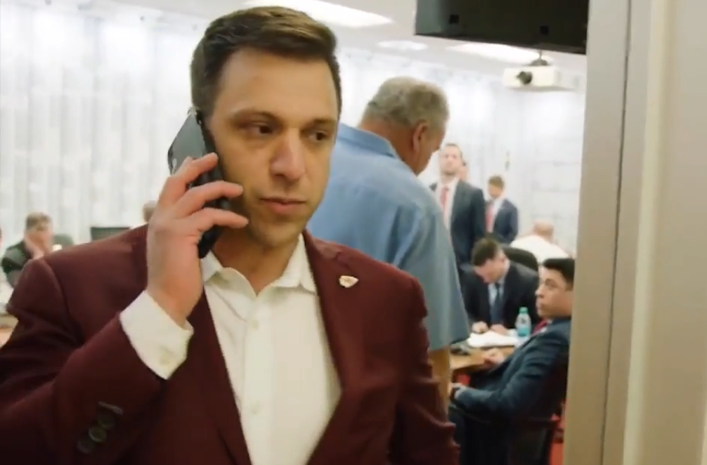 Brett Veach on the phone during the NFL draft.