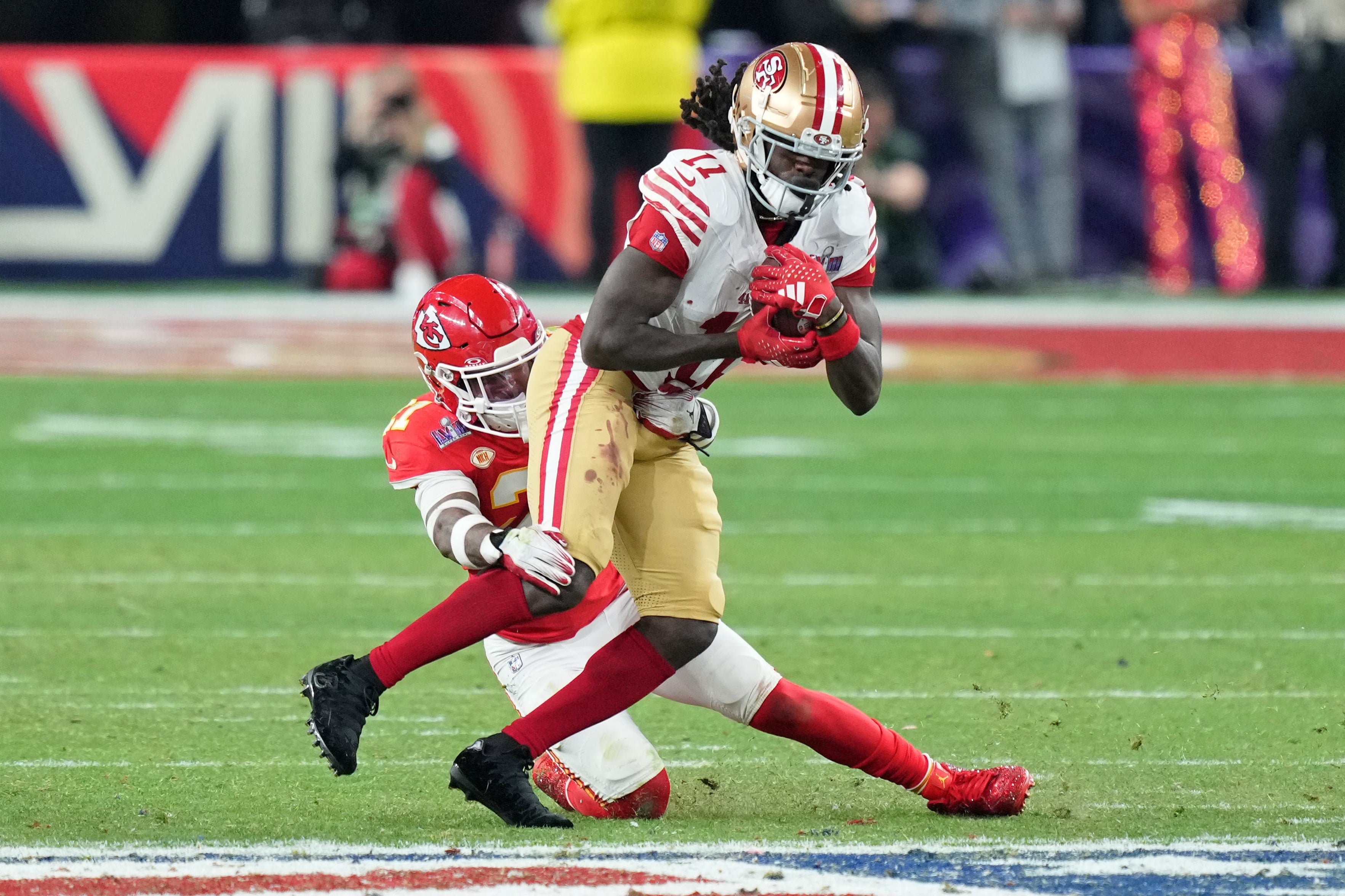 Feb 11, 2024; Paradise, Nevada, USA; Kansas City Chiefs safety Mike Edwards (21) tackles San Francisco 49ers wide receiver Brandon Aiyuk (11) during overtime of Super Bowl LVIII at Allegiant Stadium.