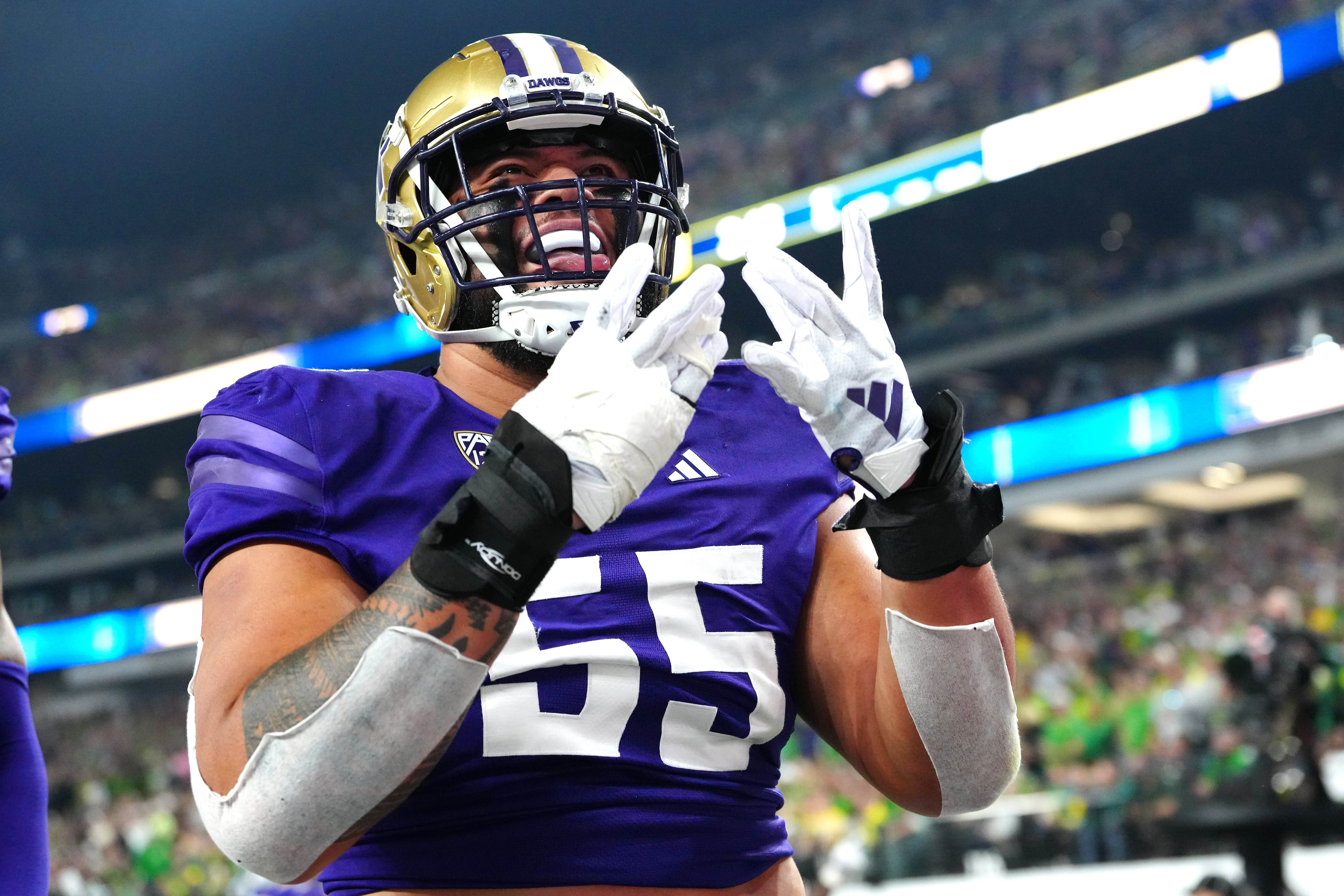 Dec 1, 2023; Las Vegas, NV, USA; Washington Huskies offensive lineman Troy Fautanu (55) celebrates after the Huskies scored against the Oregon Ducks during the first quarter at Allegiant Stadium.