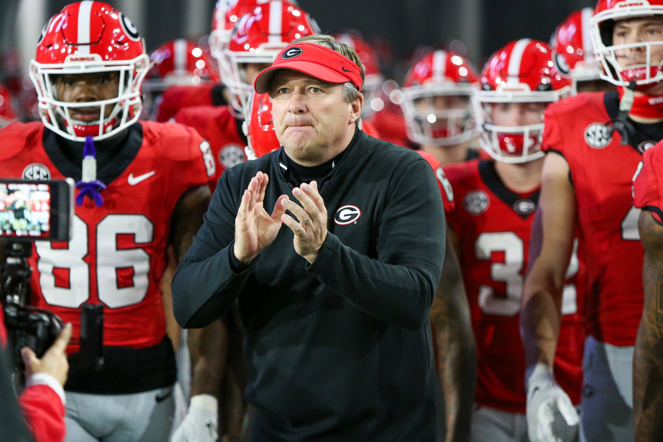 Georgia Bulldogs head coach Kirby Smart runs on the field with his team before a game against the Georgia Tech Yellow Jackets at Bobby Dodd Stadium at Hyundai Field.