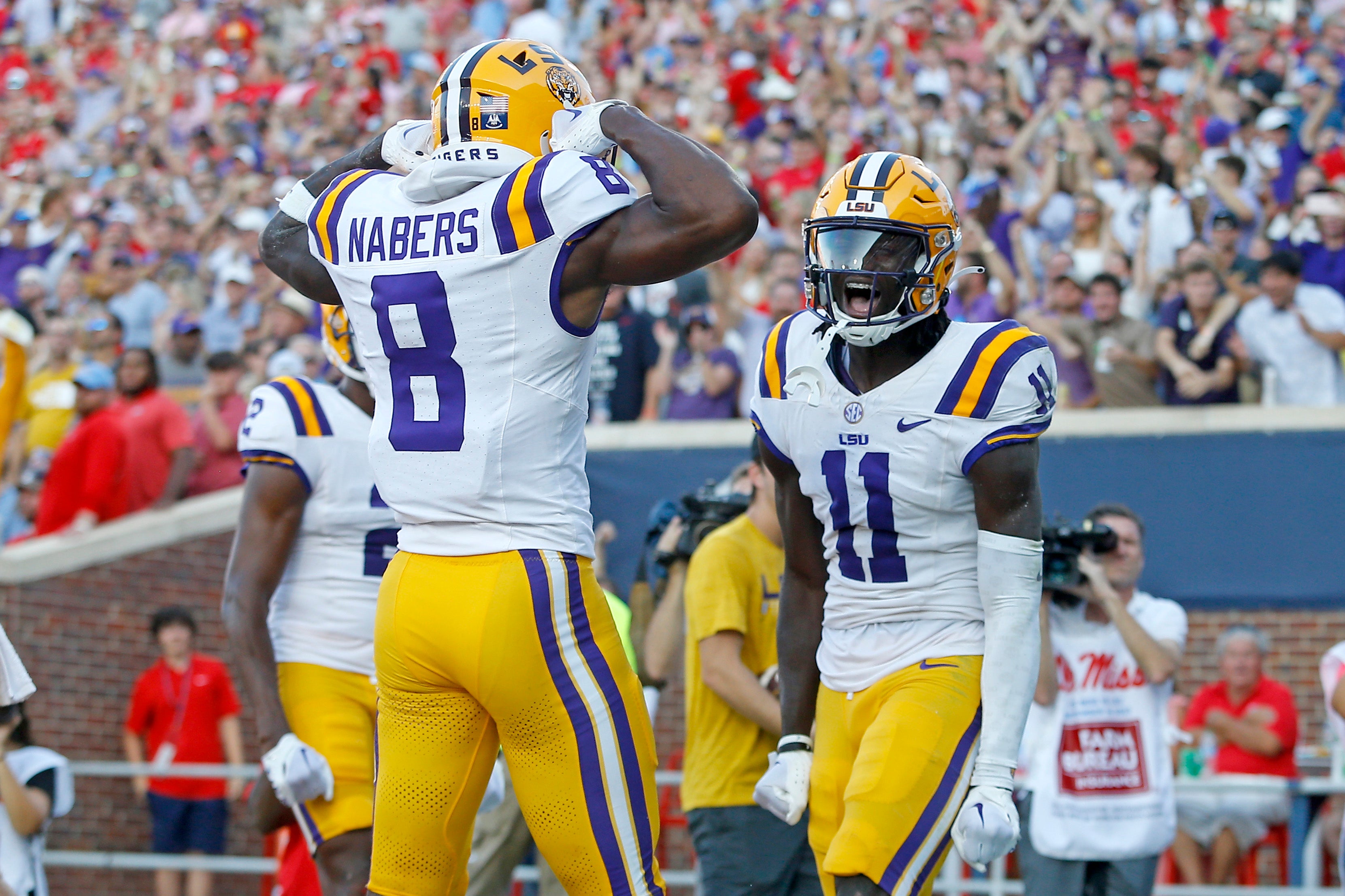 Sep 30, 2023; Oxford, Mississippi, USA; LSU Tigers wide receiver Brian Thomas Jr. (11) reacts with LSU Tigers wide receiver Malik Nabers (8) after a touchdown during the first half at Vaught-Hemingway Stadium.