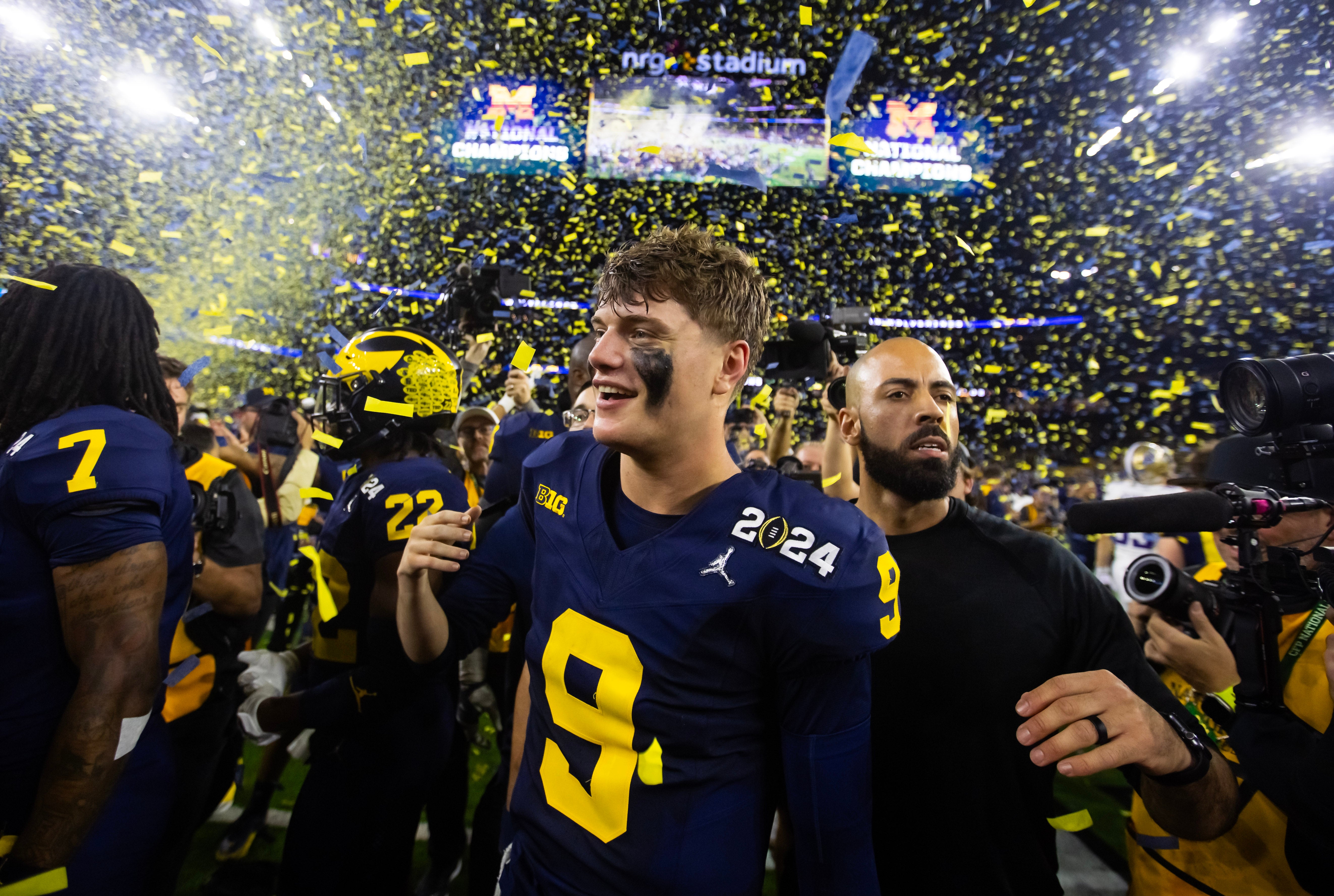 Jan 8, 2024; Houston, TX, USA; Confetti falls as Michigan Wolverines quarterback J.J. McCarthy (9) celebrates after winning 2024 College Football Playoff national championship game against the Washington Huskies at NRG Stadium.
