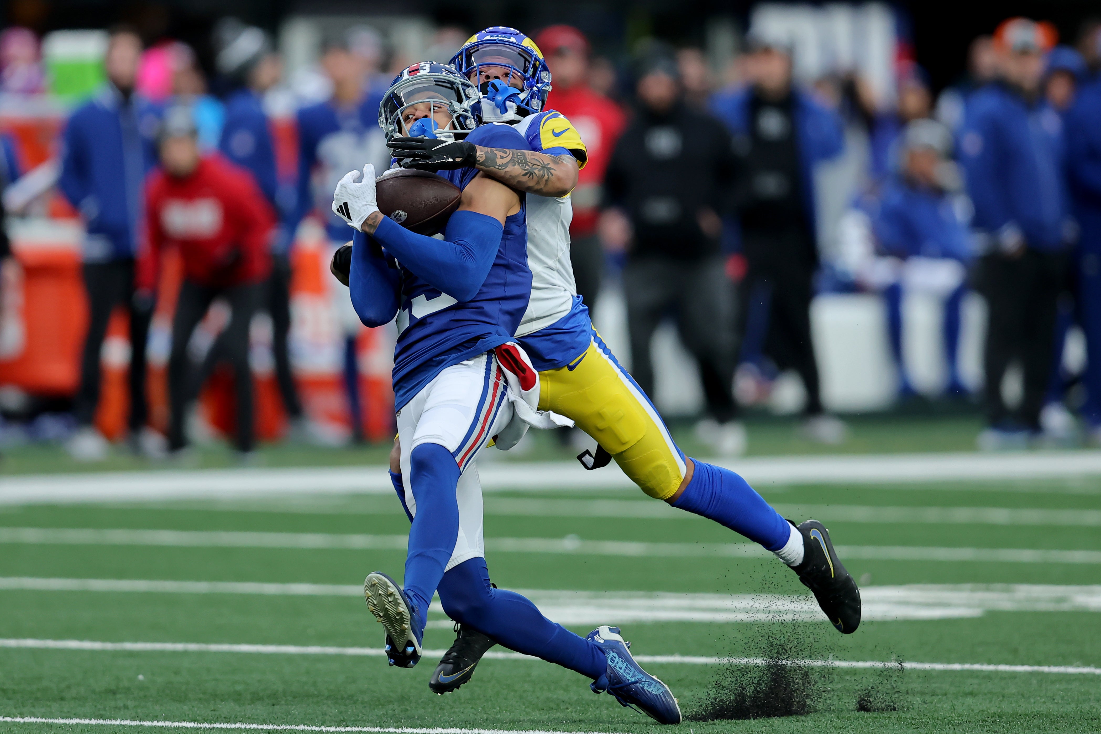 Dec 31, 2023; East Rutherford, New Jersey, USA; New York Giants wide receiver Jalin Hyatt (13) catches a pass against Los Angeles Rams cornerback Cobie Durant (14) during the fourth quarter at MetLife Stadium. The play was negated by an offensive holding penalty.