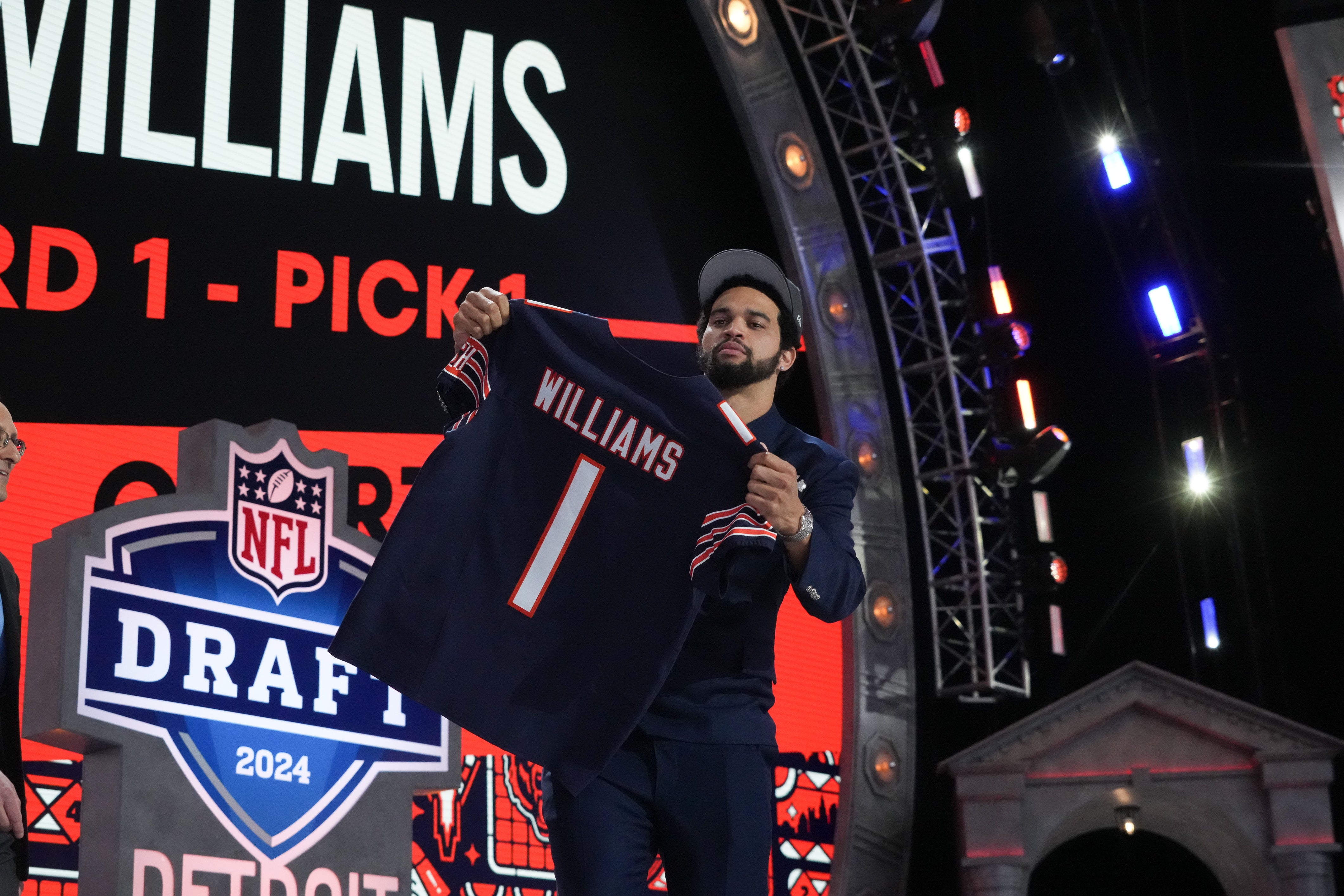 Apr 25, 2024; Detroit, MI, USA; Southern California Trojans quarterback Caleb Williams holds up his jersey after being selected by the Chicago Bears as the No. 1 pick in the first round of the 2024 NFL Draft at Campus Martius Park and Hart Plaza.