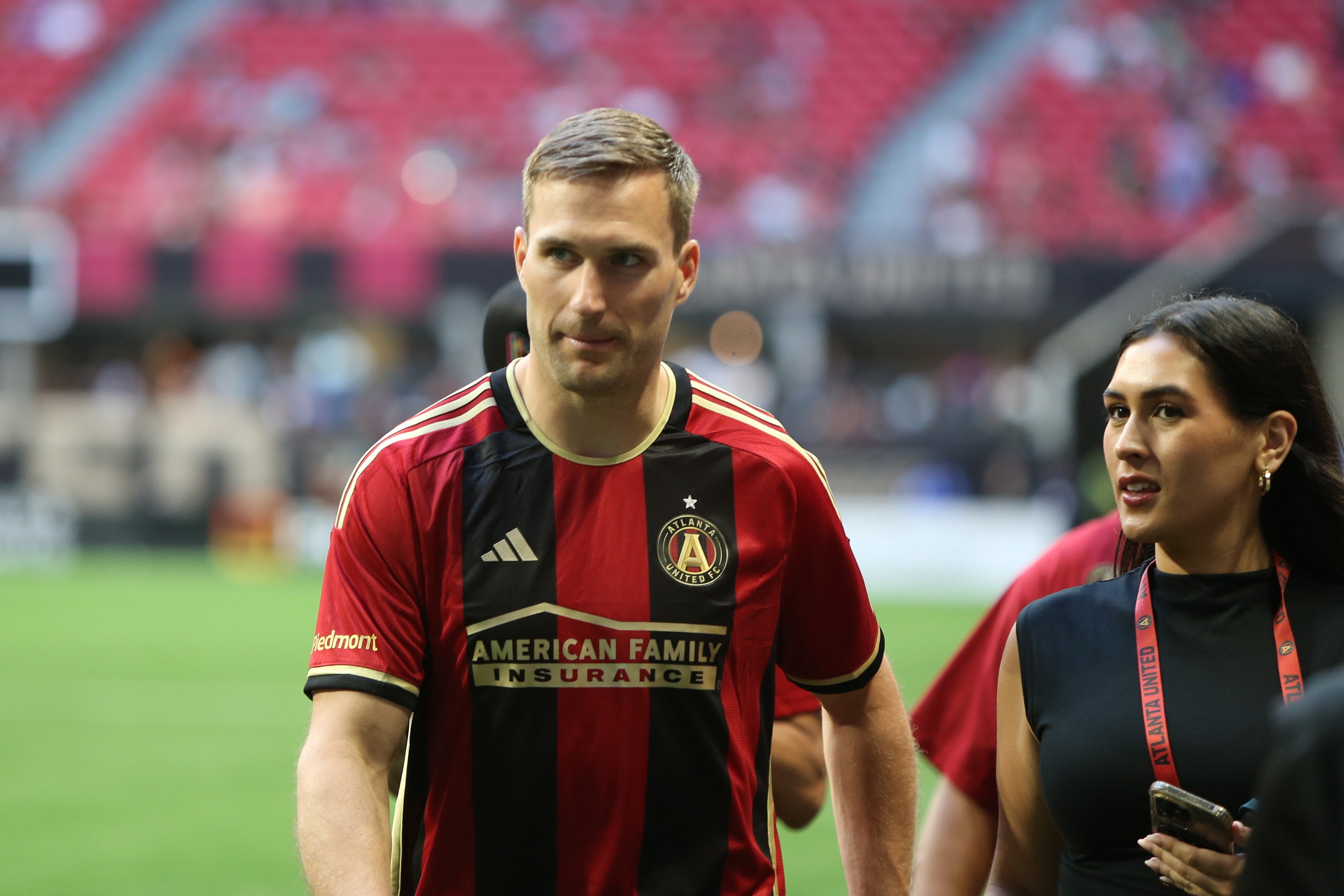 Atlanta Falcons quarterback Kirk Cousins makes an appearance on the field before a match between Atlanta United and FC Cincinnati at Mercedes-Benz Stadium.