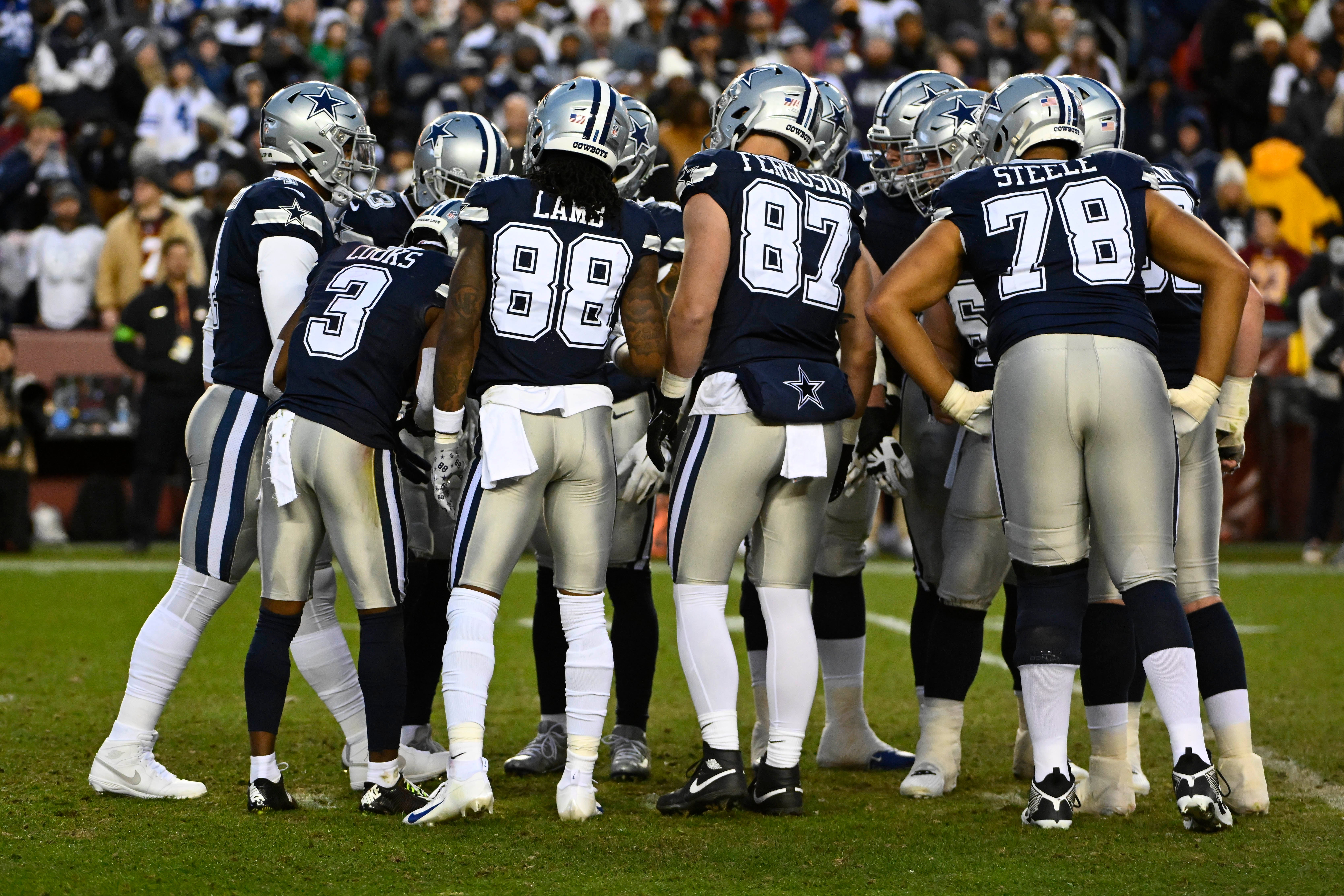 Dallas Cowboys huddle against the Washington Commanders during the first half at FedExField.