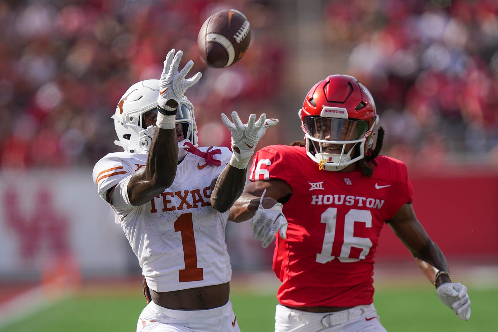 Texas wide receiver Xavier Worthy (1) catches a pass, then moves on to score a touchdown, during the Longhorns game against the University of Houston at TDECU Stadium on Saturday, Oct. 21, 2023.  