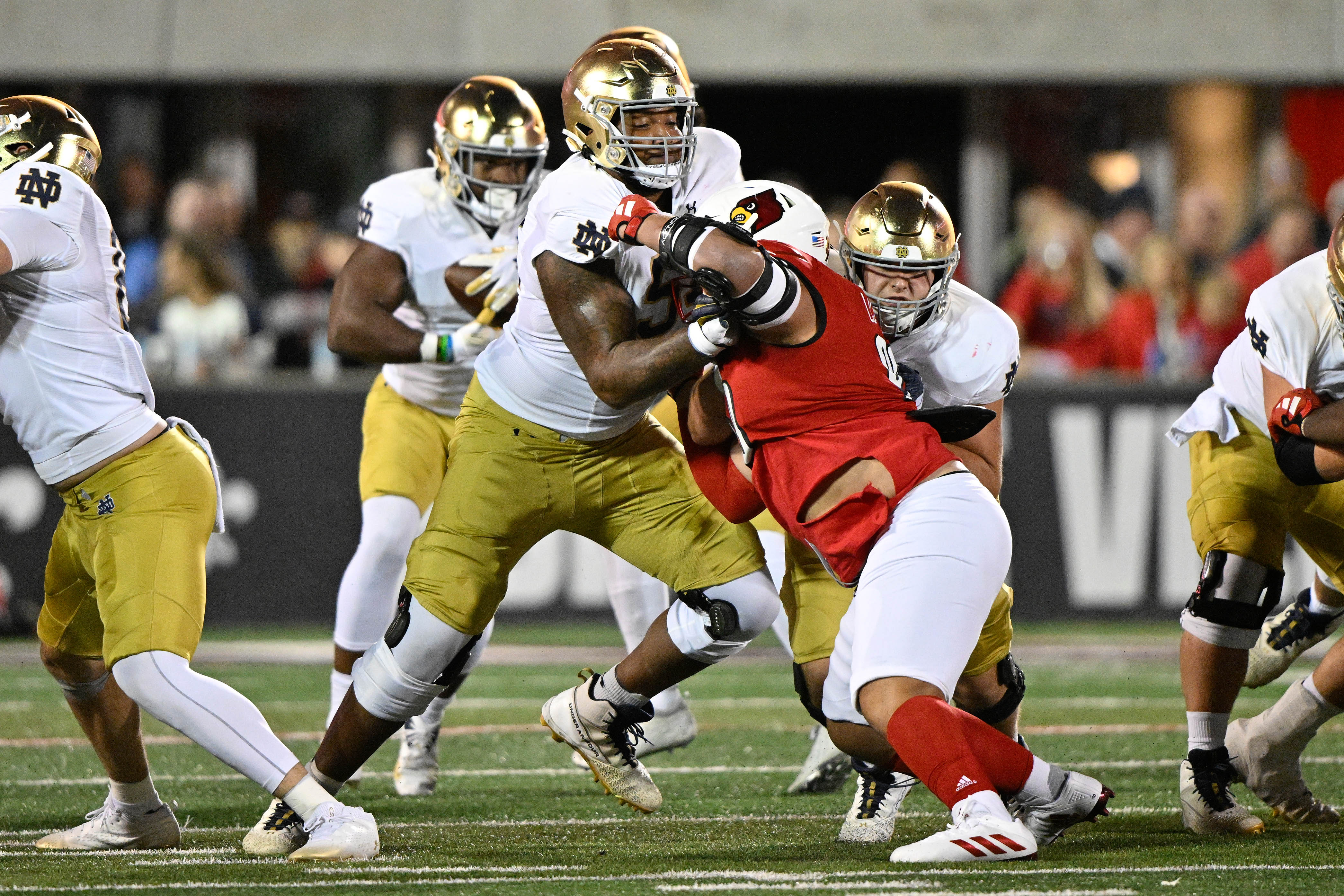 Oct 7, 2023; Louisville, Kentucky, USA; Notre Dame Fighting Irish offensive lineman Blake Fisher (54) blocks Louisville Cardinals defensive lineman Jermayne Lole (90) during the first half at L&N Federal Credit Union Stadium. Louisville defeated Notre Dame 33-20.