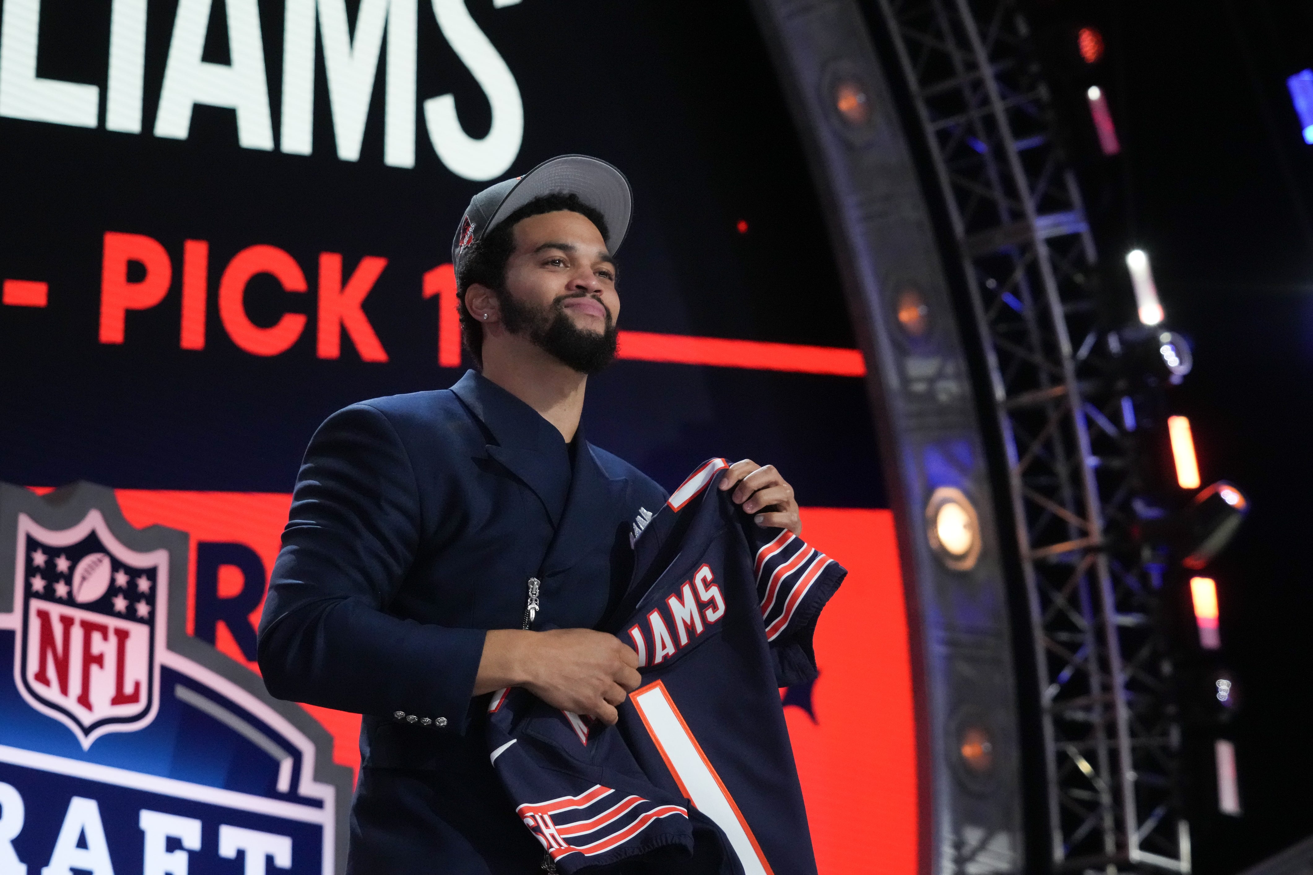 Apr 25, 2024; Detroit, MI, USA; Southern California Trojans quarterback Caleb Williams holds up his jersey after being selected by the Chicago Bears as the No. 1 pick in the first round of the 2024 NFL Draft at Campus Martius Park and Hart Plaza.