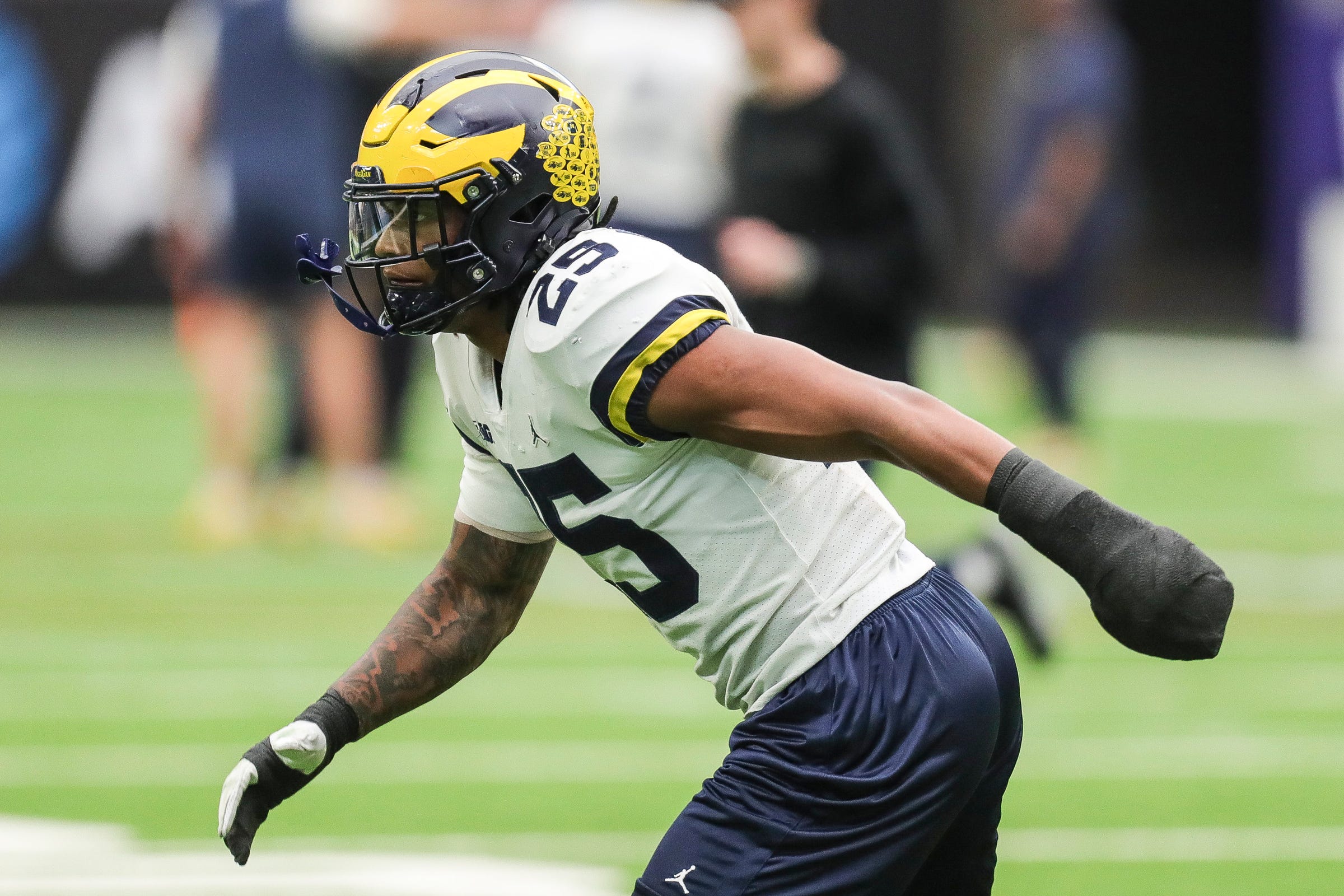 Michigan linebacker Junior Colson (25) runs a drill during open practice at NRG Stadium in Houston, Texas on Saturday, Jan. 6, 2024.