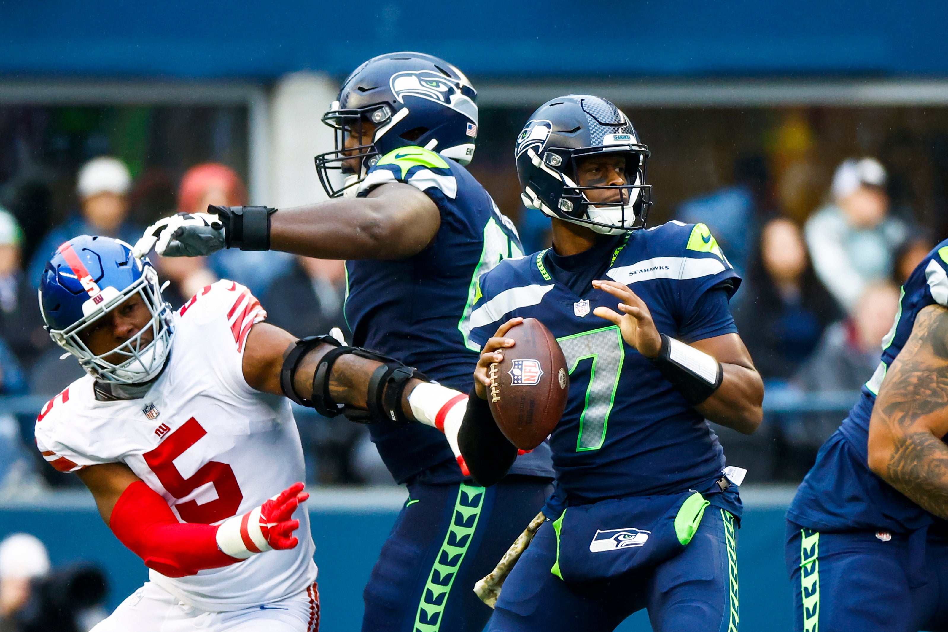 Oct 30, 2022; Seattle, Washington, USA; Seattle Seahawks quarterback Geno Smith (7) looks to pass as offensive tackle Charles Cross (67) backs against New York Giants defensive end Kayvon Thibodeaux (5) during the third quarter at Lumen Field.