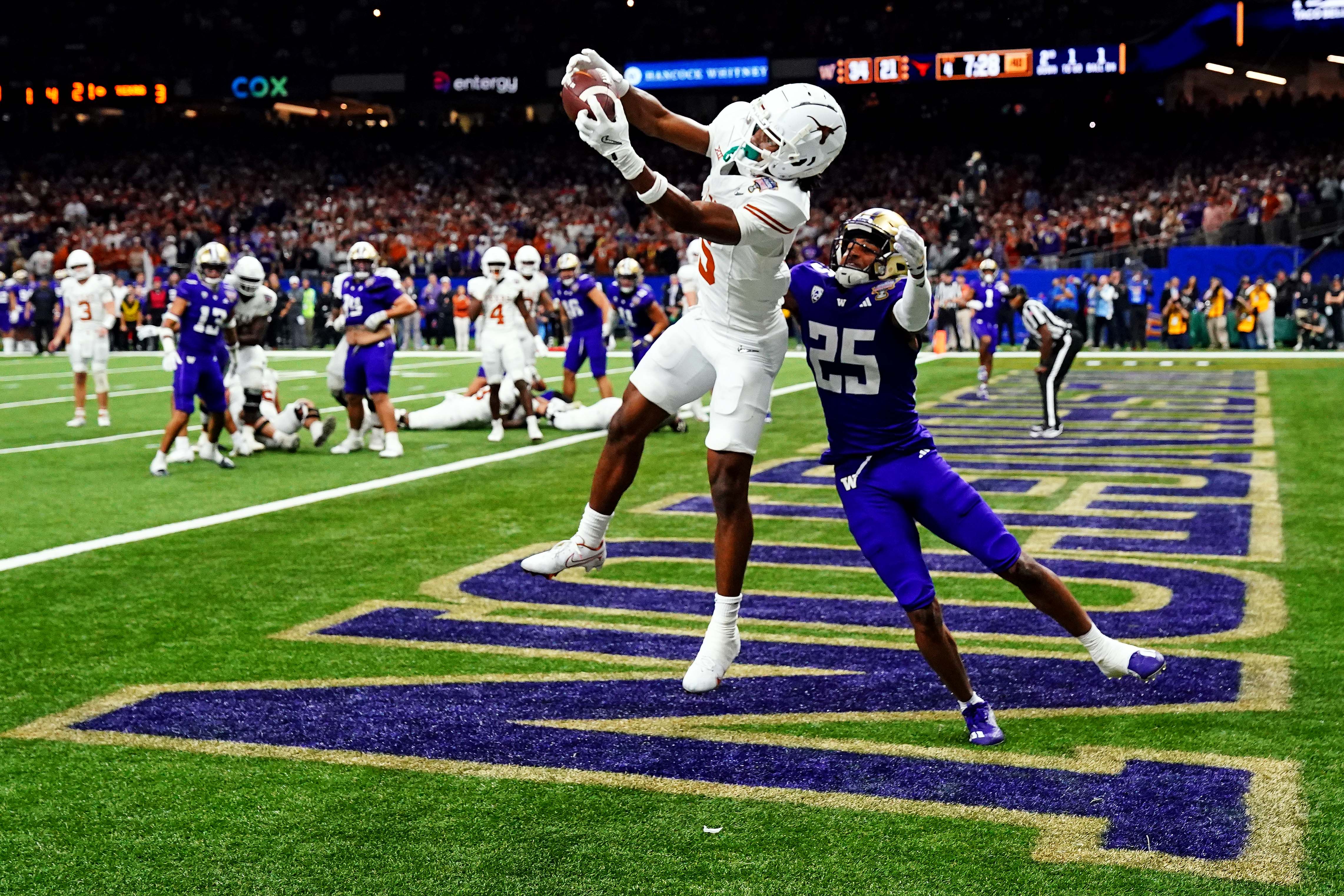 Jan 1, 2024; New Orleans, LA, USA; Texas Longhorns wide receiver Adonai Mitchell (5) catches a touchdown pass against Washington Huskies running back Ryder Bumgarner (25) during the fourth quarter in the 2024 Sugar Bowl college football playoff semifinal game at Caesars Superdome.
