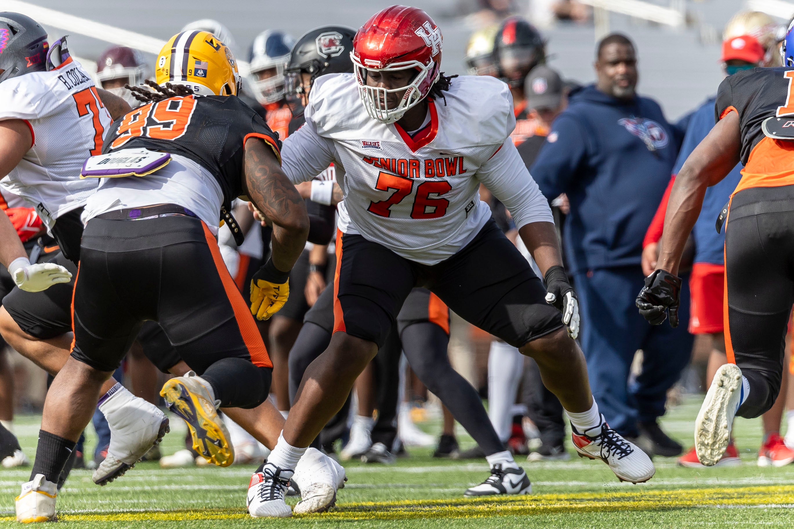 Caption: Feb 1, 2024; Mobile, AL, USA; American offensive lineman Patrick Paul of Houston (76) faces off against American defensive lineman Jordan Jefferson of LSU (99) during practice for the American team at Hancock Whitney Stadium.