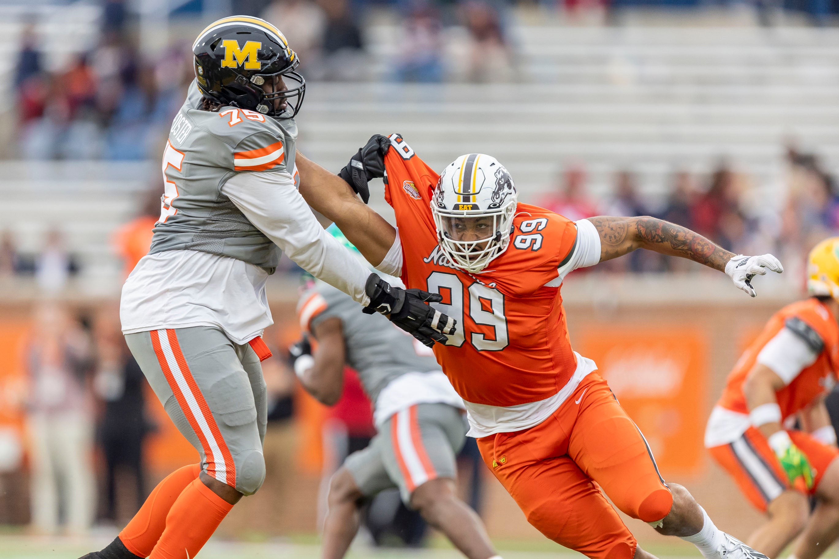 American offensive lineman Javon Foster of Missouri (75) battle National edge Marshawn Kneeland of Western Michigan (99) during the second half of the 2024 Senior Bowl football game at Hancock Whitney Stadium.