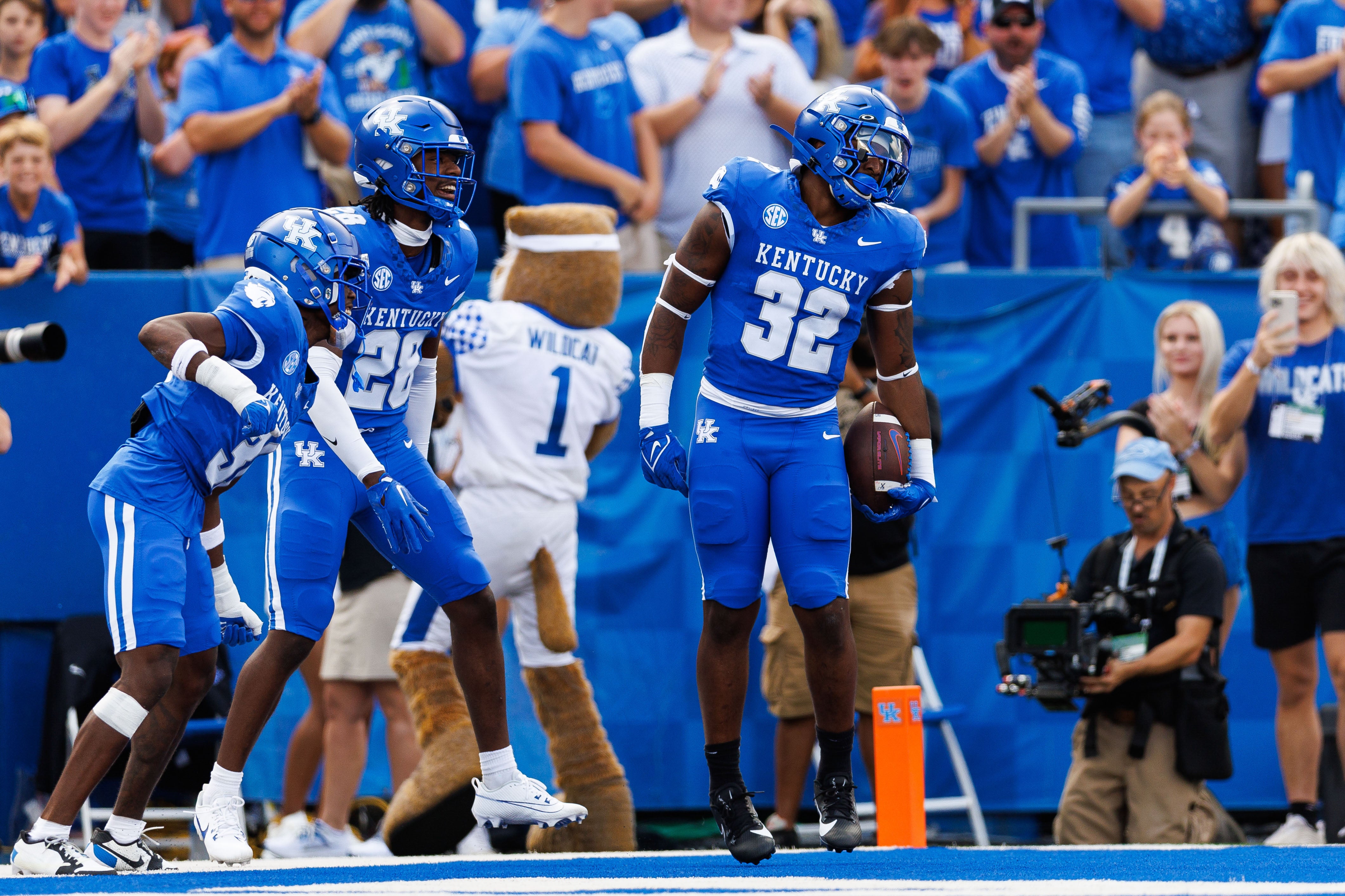 Sep 30, 2023; Lexington, Kentucky, USA; Kentucky Wildcats linebacker Trevin Wallace (32) celebrates an interception during the first quarter against the Florida Gators at Kroger Field. Mandatory Credit: Jordan Prather-USA TODAY Sports