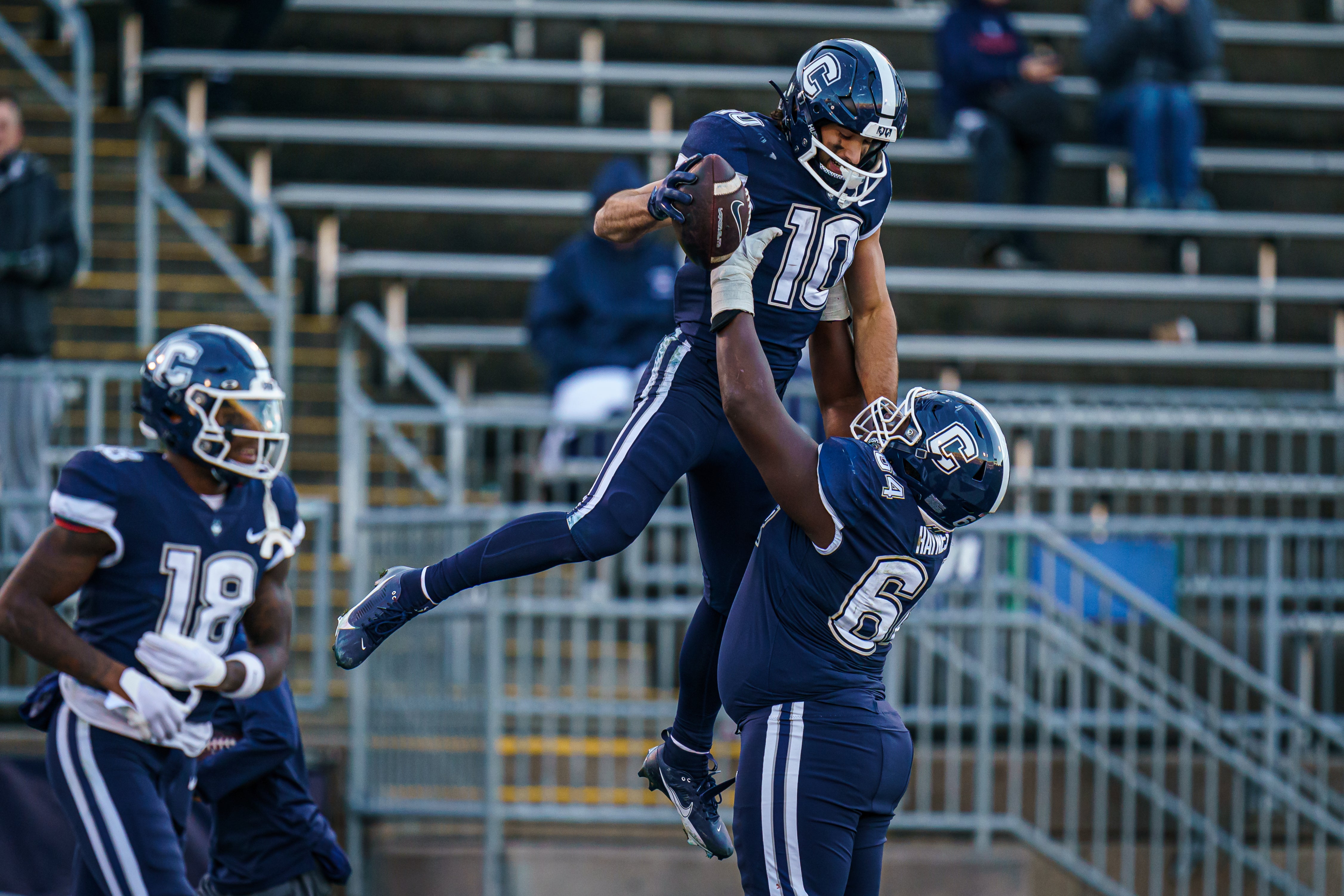 Nov 18, 2023; East Hartford, Connecticut, USA; UConn Huskies wide receiver Brett Buckman (10) is congratulated after his touchdown by offensive lineman Christian Haynes (64) against the Sacred Heart Pioneers in the second half at Rentschler Field at Pratt & Whitney Stadium.