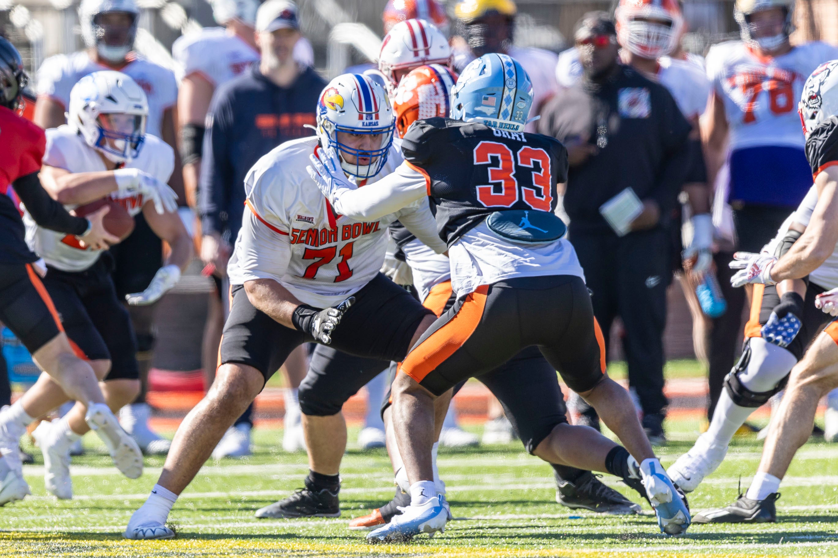 Jan 31, 2024; Mobile, AL, USA; National offensive lineman Dominick Puni of Kansas (71) blocks against National linebacker Cedric Gray of North Carolina (33) during practice for the National team at Hancock Whitney Stadium.