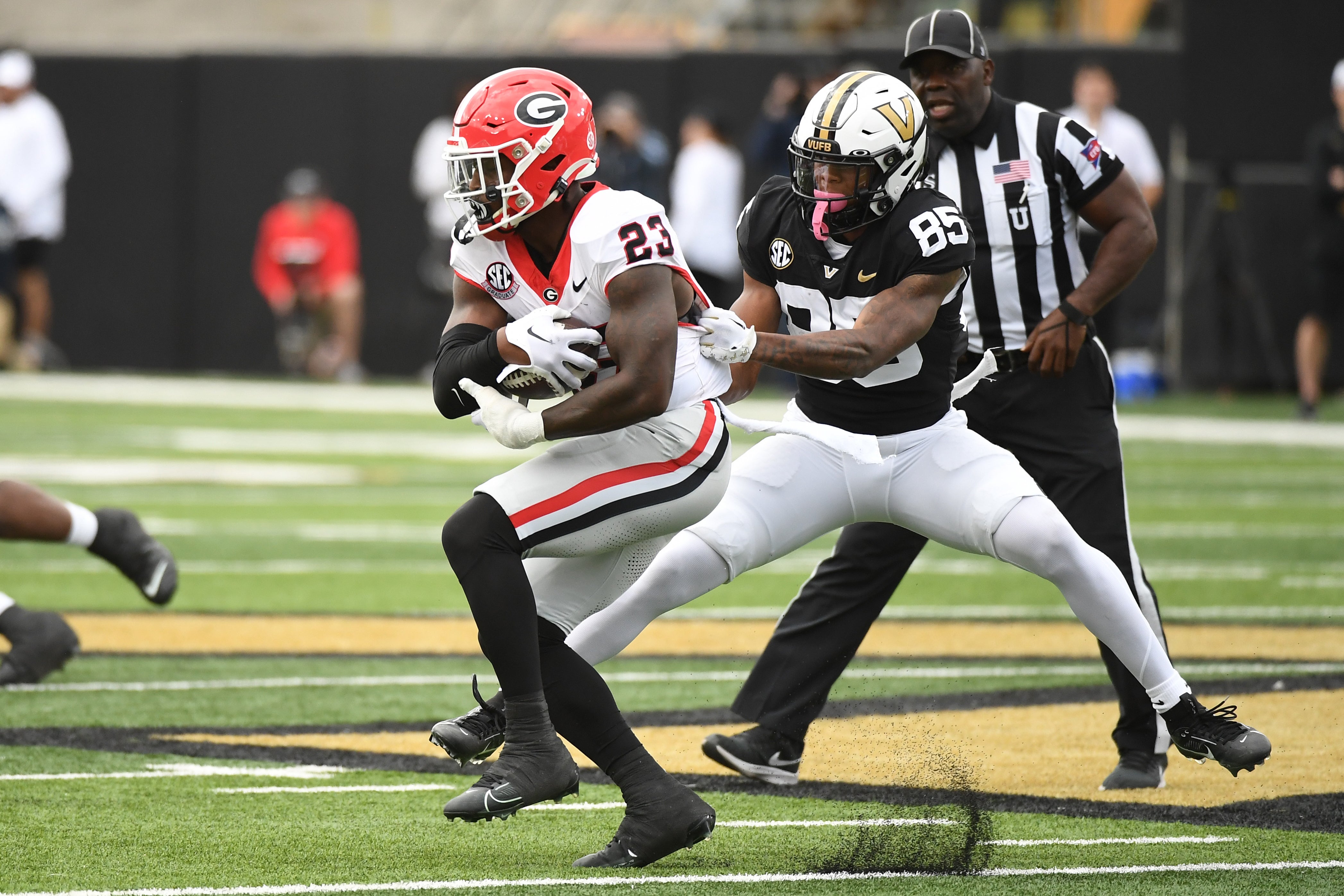 Oct 14, 2023; Nashville, Tennessee, USA; Georgia Bulldogs defensive back Tykee Smith (23) is tackled after intercepting a pass intended for Vanderbilt Commodores wide receiver Junior Sherrill (85) during the first half at FirstBank Stadium.